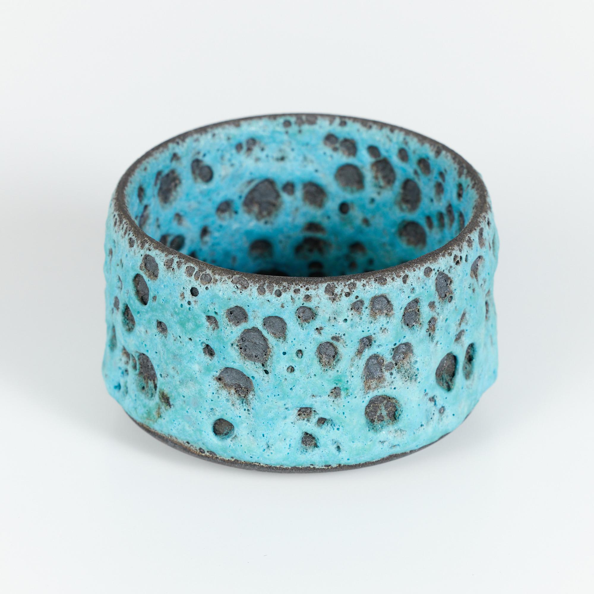 Ocean inspired ceramic bowl with steep sides. This piece showcases a blue chemistry glazed interior and exterior. The texture most resembles a sea coral or lava rock.

Dimensions
4.5