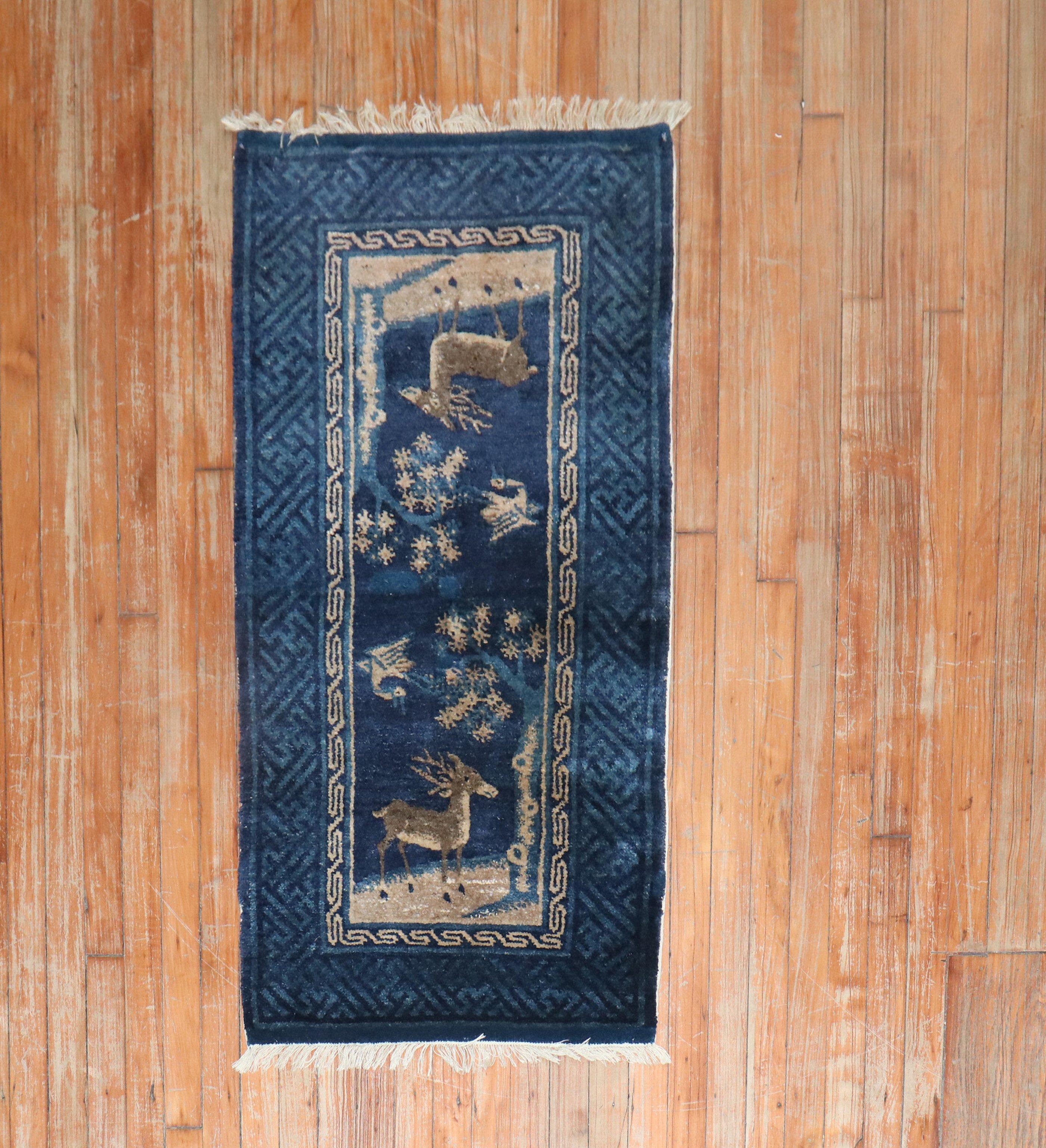 An early 20th-century Chinese Pictorial rug with an animal motif in navy and brown

Measures: 2'1' x 4'1''.