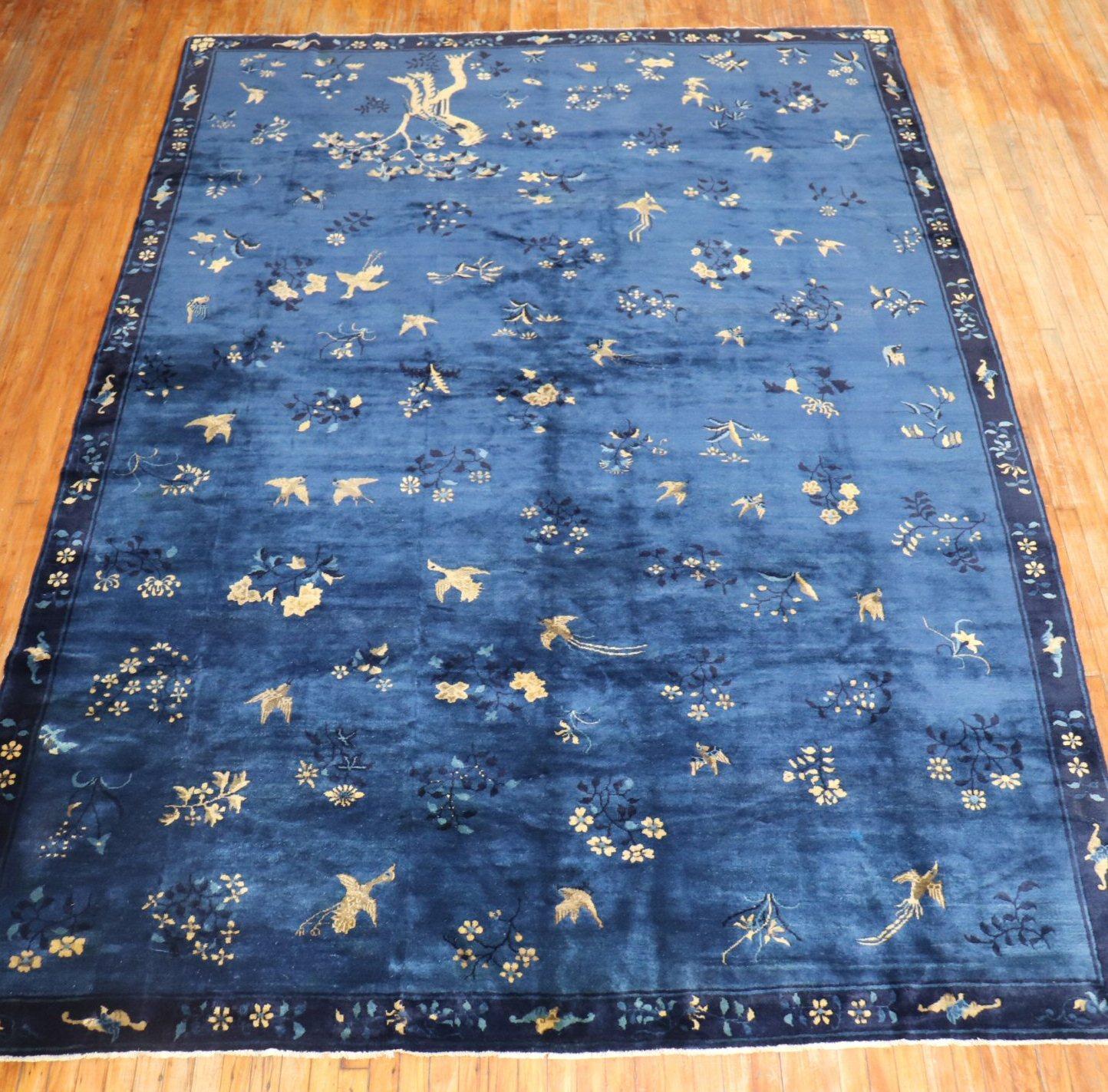 An early 20th century fine quality Chinese pictorial rug with birds and pigeons floating on a blue field

Measures: 8'6
