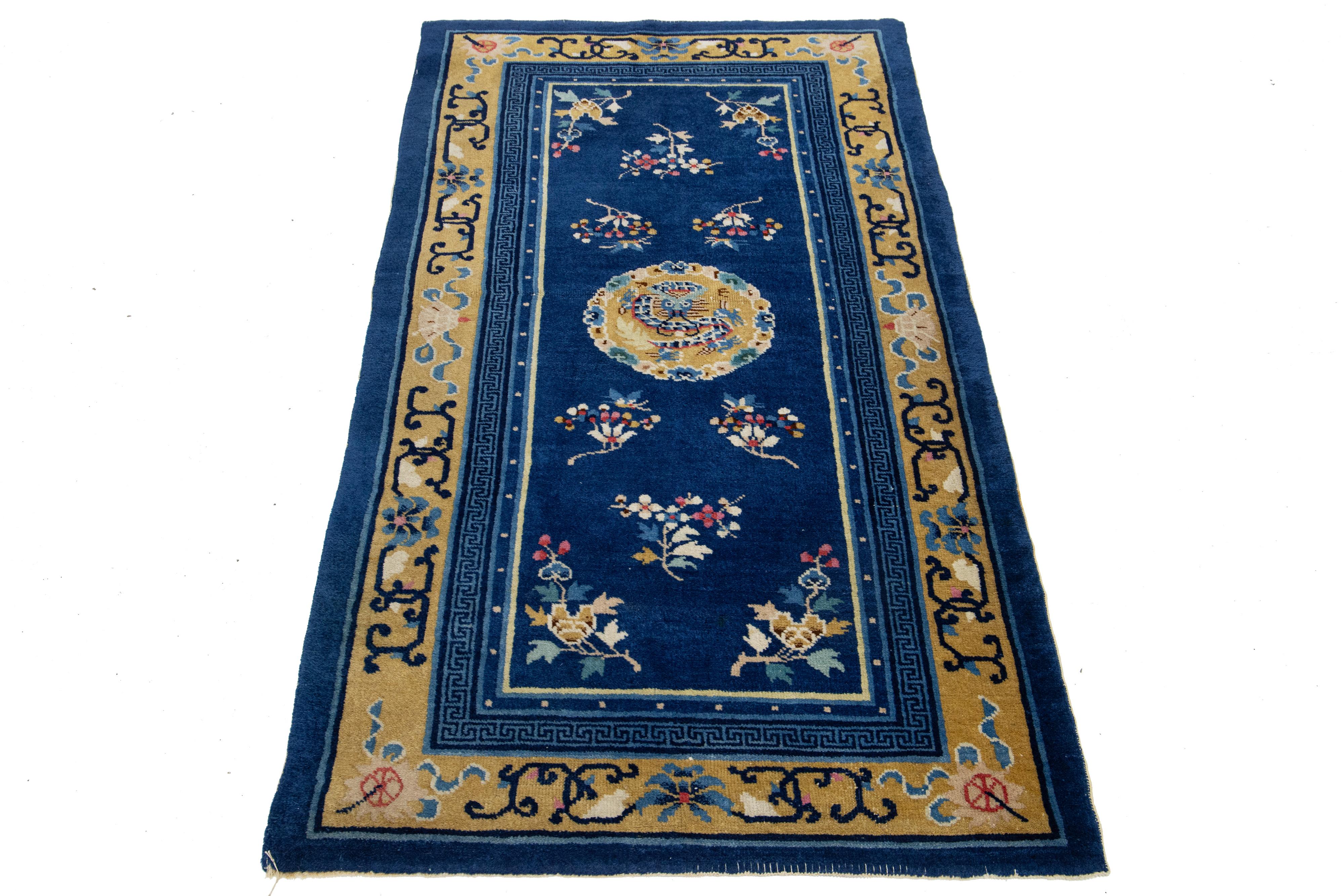 This stunning antique Peking Chinese hand-knotted wool rug features a rich navy blue field adorned with vibrant yellow accents showcasing traditional Chinese dragon designs.

This rug measures 3' x 5'10