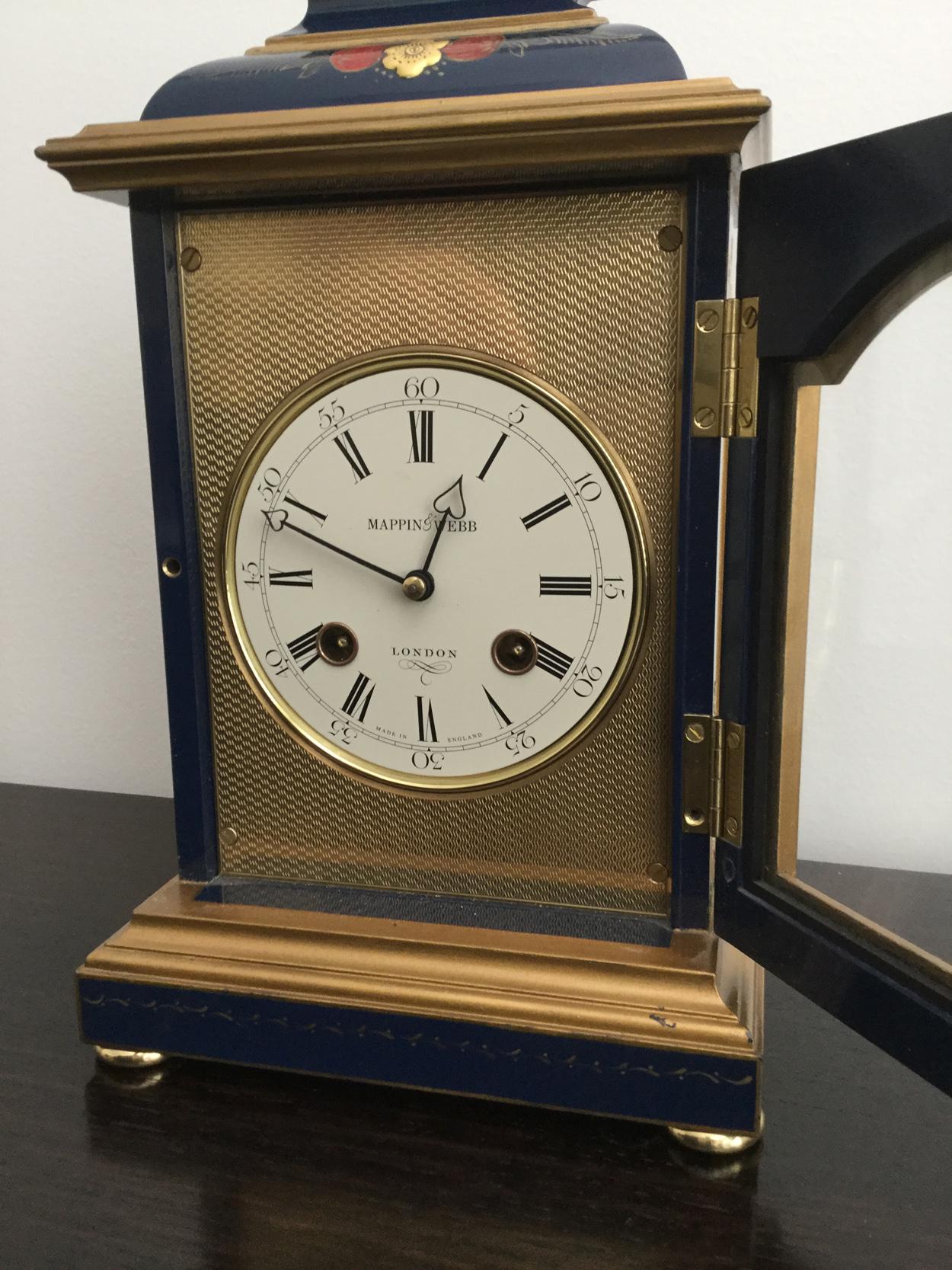 An attractive blue Chinoiserie Georgian style bracket clock, the white dial inscribed Mappin & Webb, London, with gold engine turned surround. Case all-over decorated in Chinoiserie relief mouldings of garden scenes, flowers, temple, maiden and