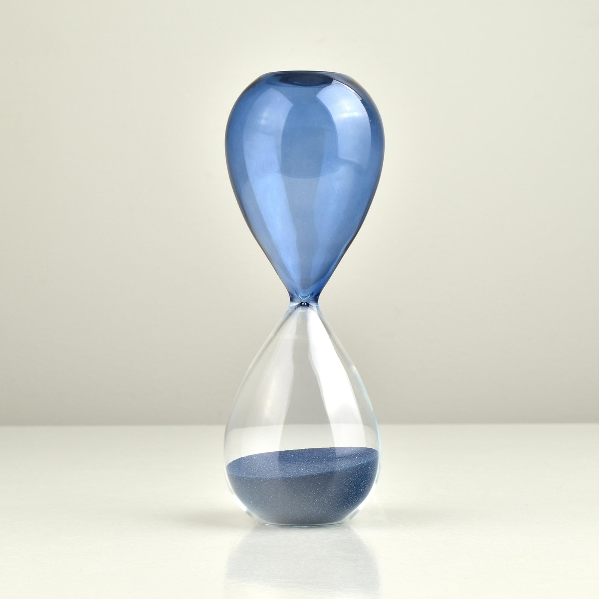 A hand blown art glass hourglass made of blue and clear glass in style of Paolo Venini.