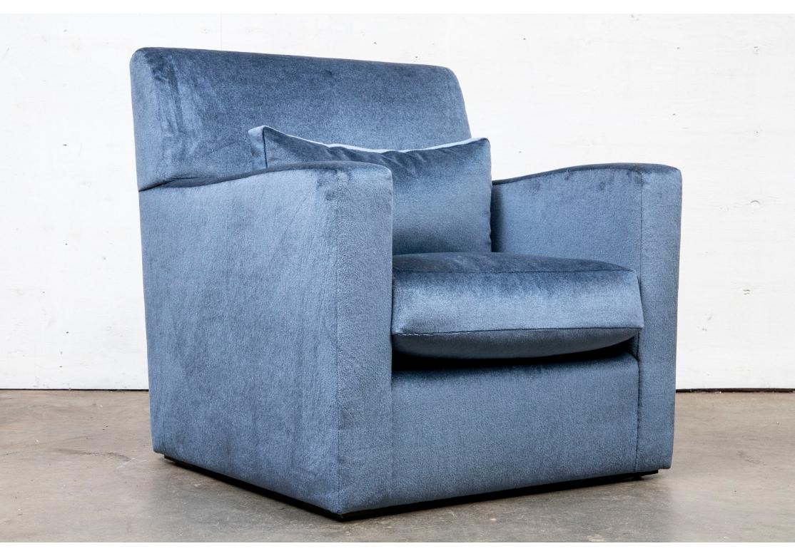 With a Cube form frame and lumbar cushion upholstered in a mohair type fabric in an attractive dusty blue with a sheen. The chair resting on four short walnut plinth feet. Comes with a lumbar pillow. The Chair is very comfortable. 

Dimensions;

33