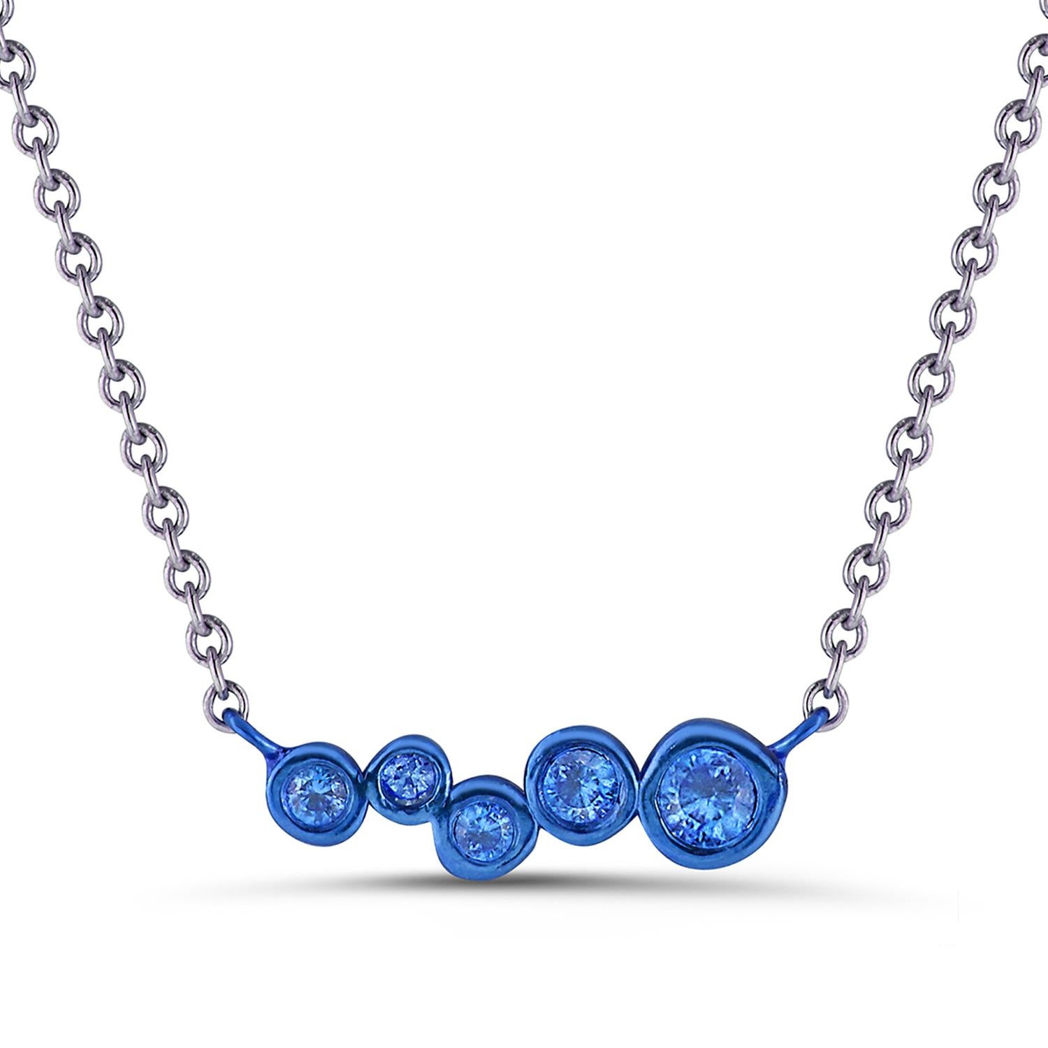 Hi June Parker's version of the classic bar pendant sprinkled with tapering sizes of Blue Sapphires ceramic plated with a deep Blue to add a pop of electric color to your neck.

Inspired by seeing the cross-section view of life, as if slicing a tree