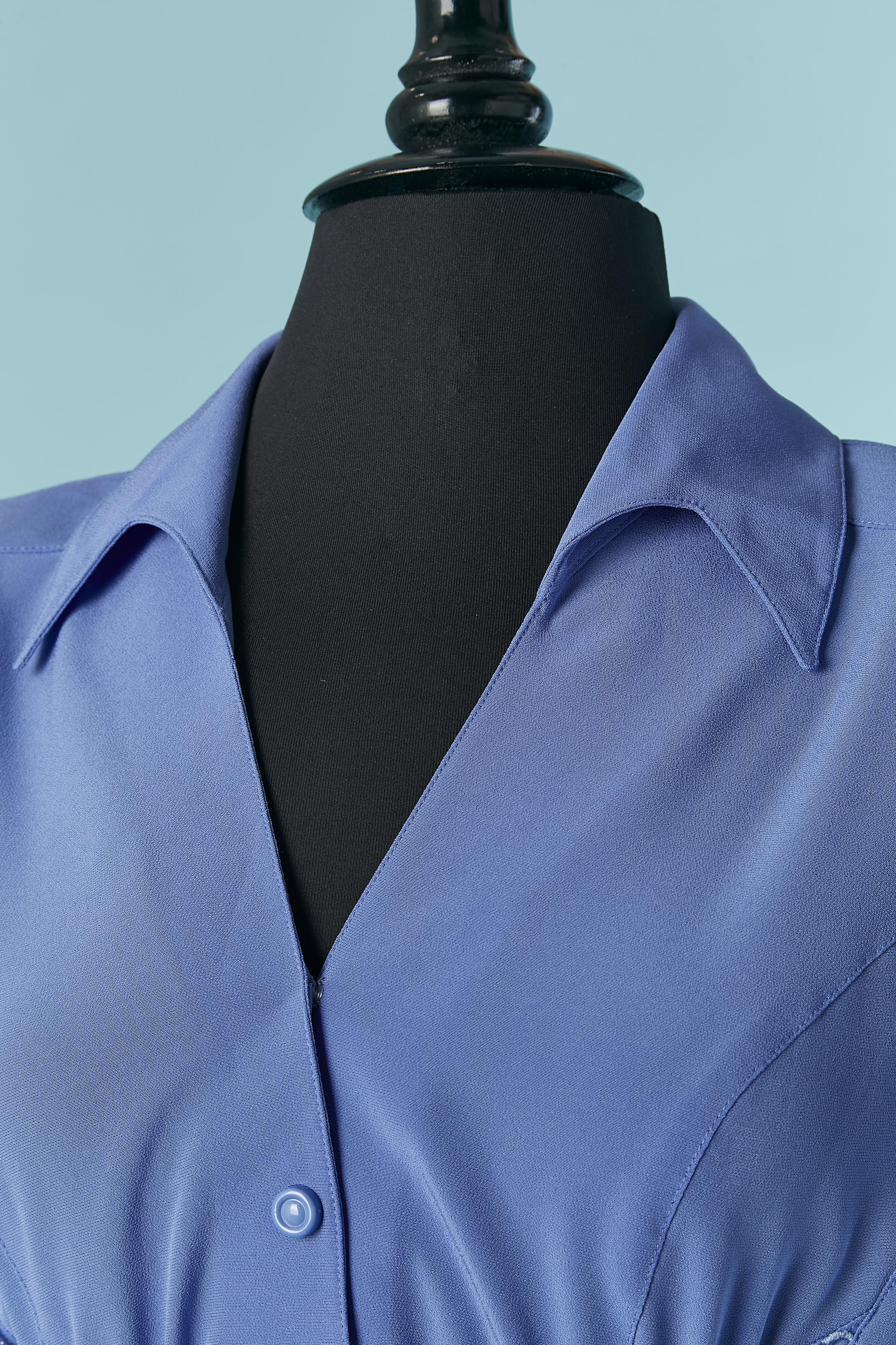 Blue cocktail dress with blue string around the waist and back. 
Fabric ccomposition: 100% polyester. Acetate lining on the bottom part of the dress ( from the waist until bottom) 
Snap closure on the middle front. Cut-work. Raglan sleeve.