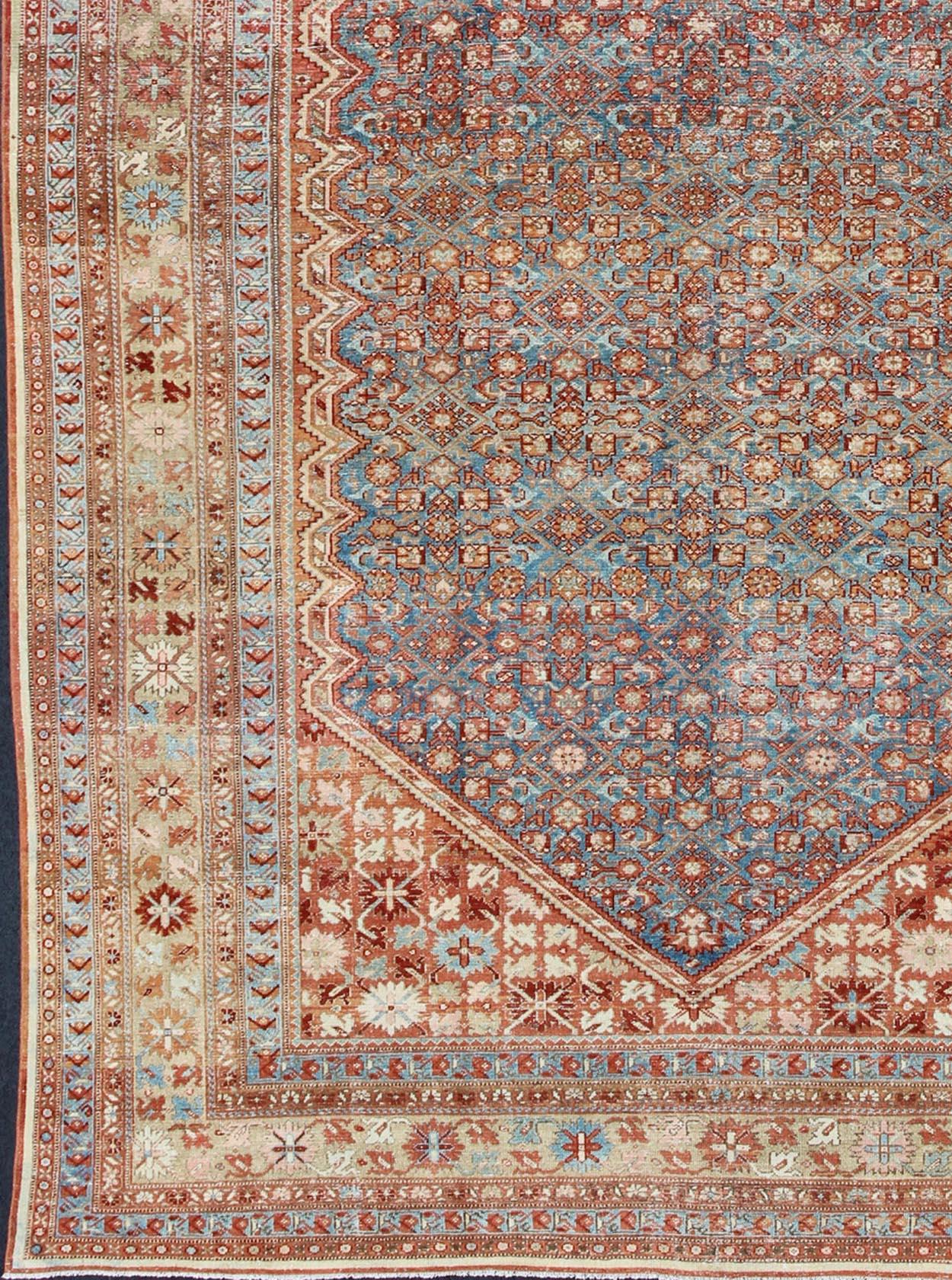 Colorful antique Persian Malayer rug with all-over design in rust and blue. Keivan Woven Arts / rug sus-1807-276, country of origin / type: Iran / Malayer, circa 1910.
Measures: 10'3 x 16'.
This antique Persian Malayer rug was handwoven in the early