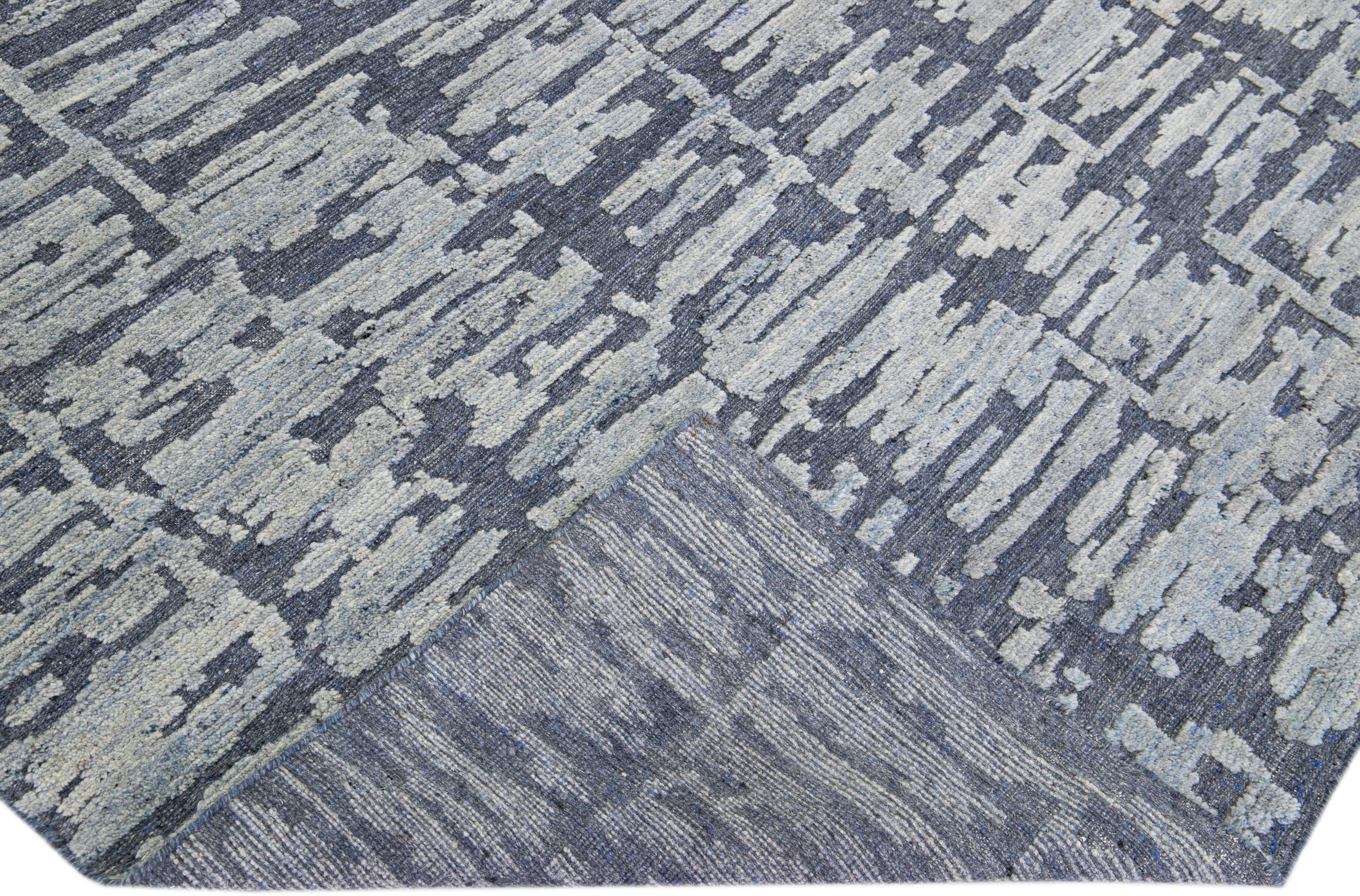Beautiful Contemporary Thom Filicia Home Collection Rugs. This Indian hand-knotted rug is made of wool and has a blue color field and light gray accents all over the design. 
Thom Filicia´s eye for exquisite detailing and beautiful texture shines