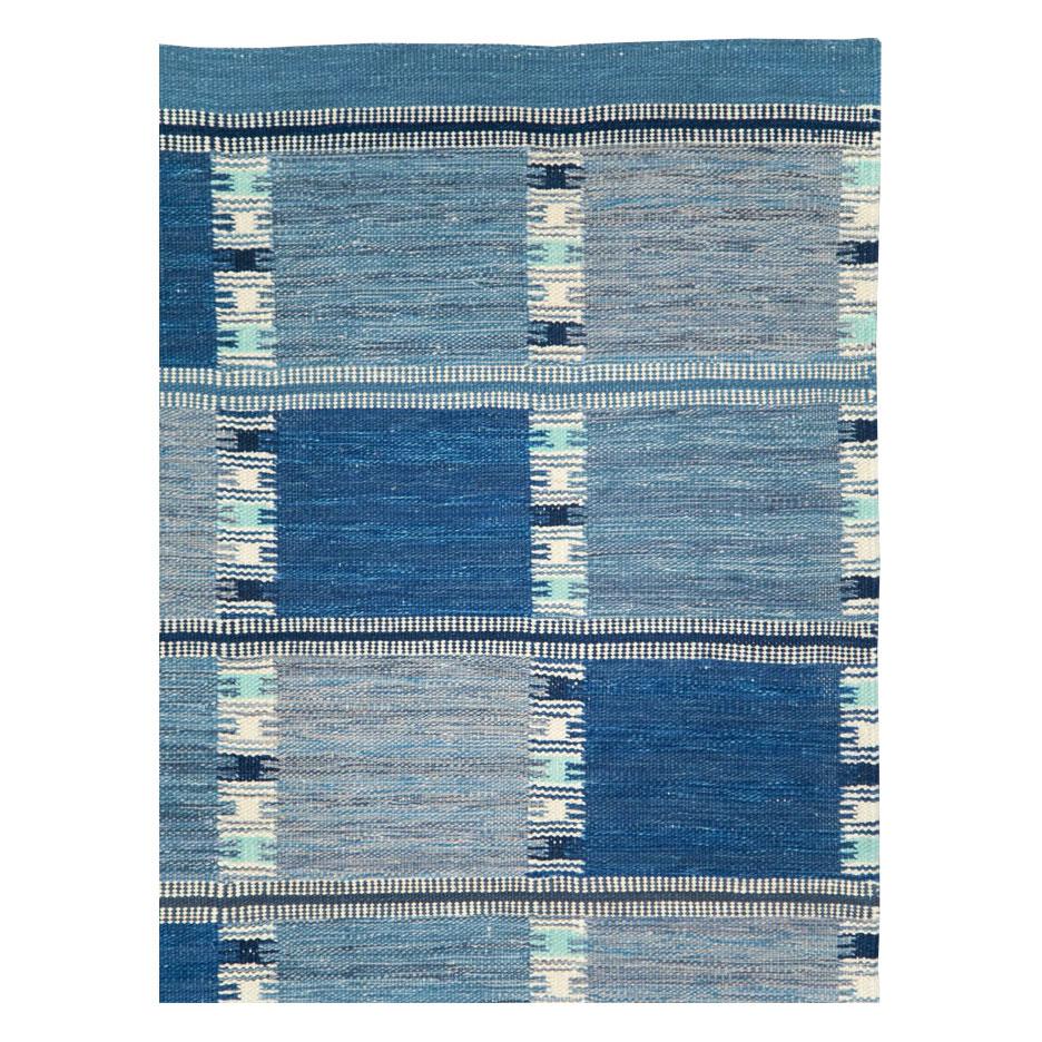 A blue modern Turkish flat-weave room size carpet handmade during the 21st century. The design and weave are inspired by vintage Swedish Kilim rugs from the mid-20th century period.

Measures: 8' 3