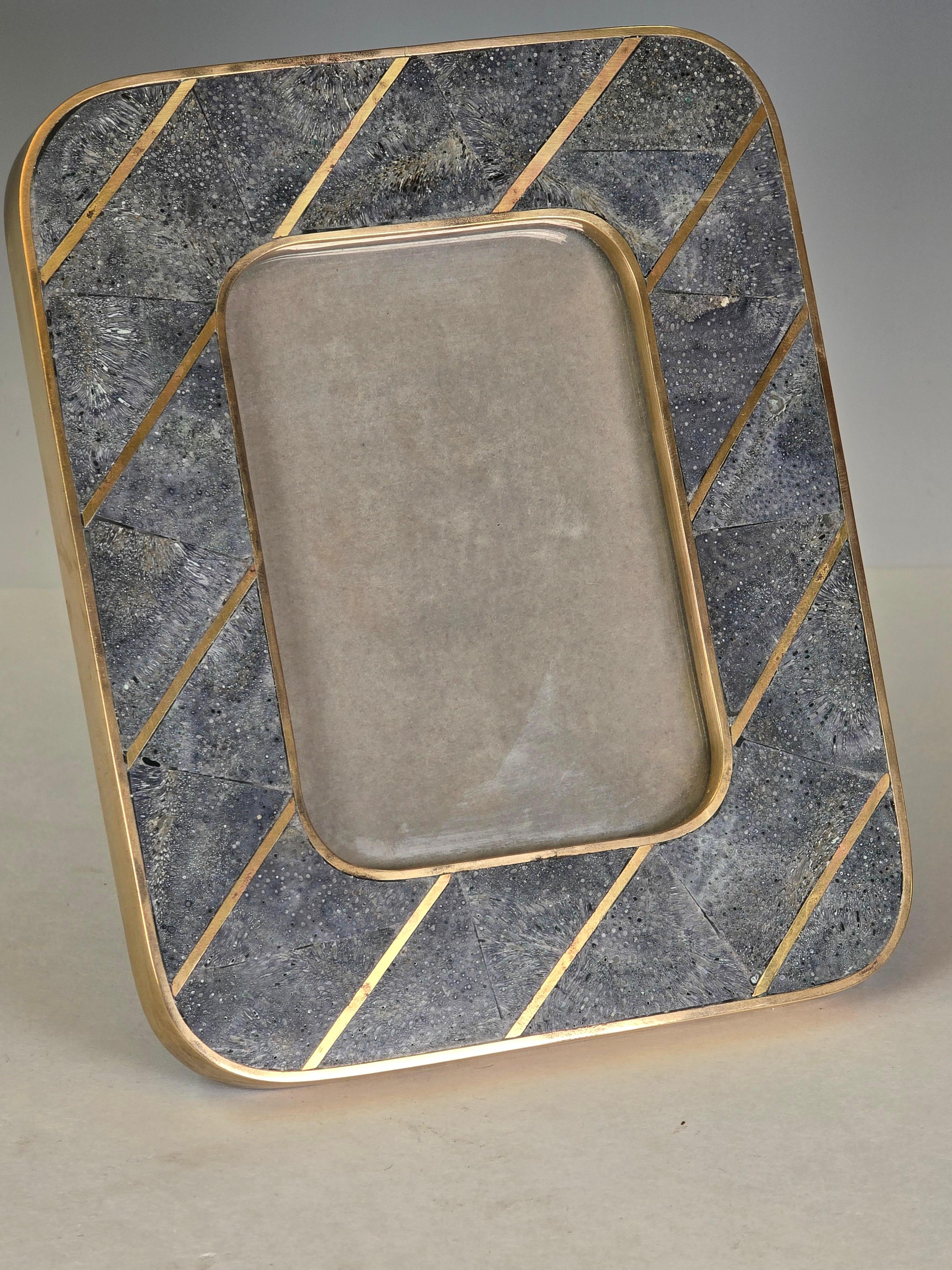 A rare and exquisitely crafted photo frame by Maitland-Smith, featuring hand-inlaid tessellated blue coral set within a sleek brass frame. Created in the 1980s, this piece reflects the design sensibilities of the era—bold, sculptural, and richly