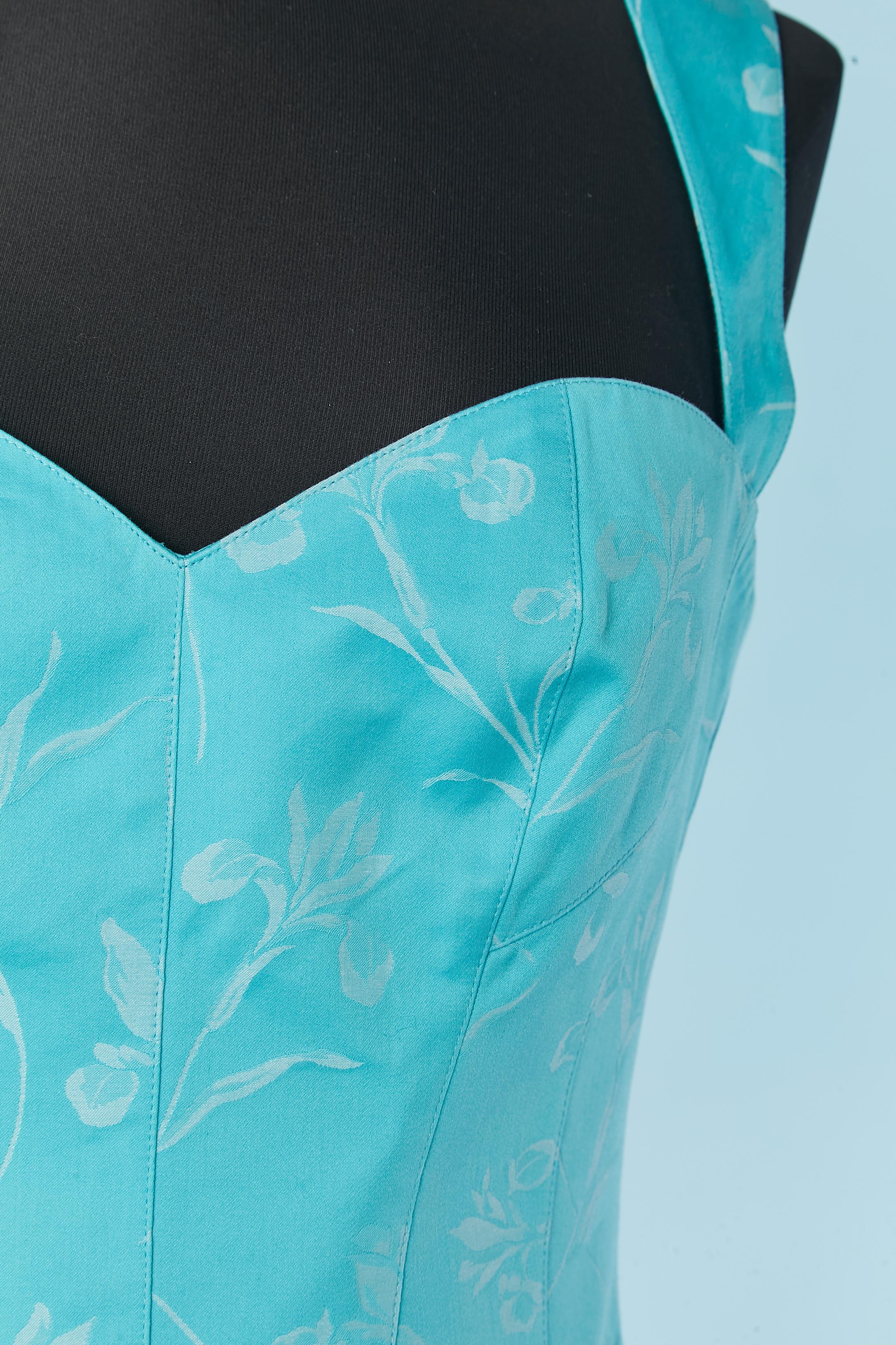 Cotone jacquard blu con motivo floreale. Tasca su entrambi i lati. La fodera del bustier è priva di etichetta con la composizione del tessuto, ma probabilmente si tratta di rayon. Chiusura con zip al centro della schiena. Tracolla regolabile con