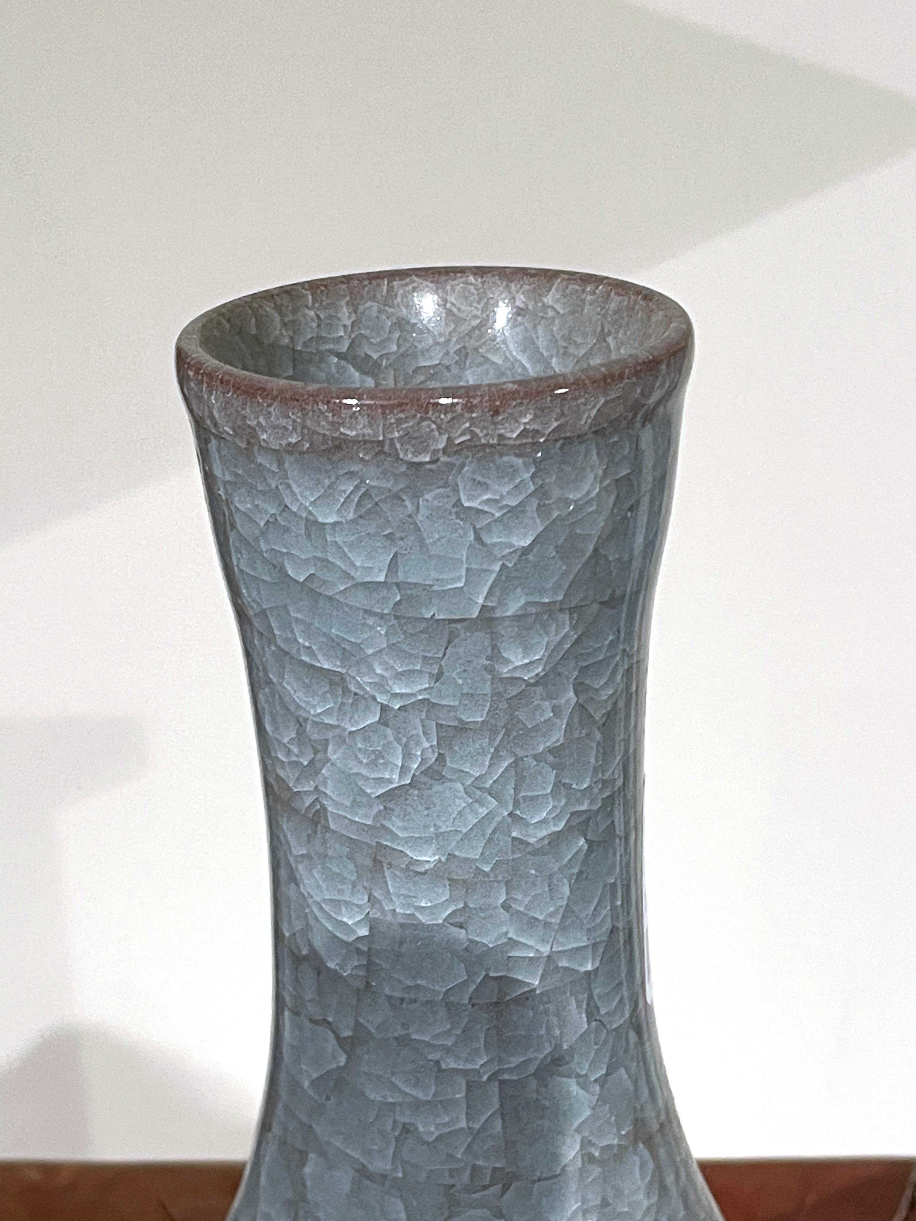Contemporary Chinese blue vase with crackle glaze.
Classic funnel neck.
From a large collection with varying shapes and sizes.
