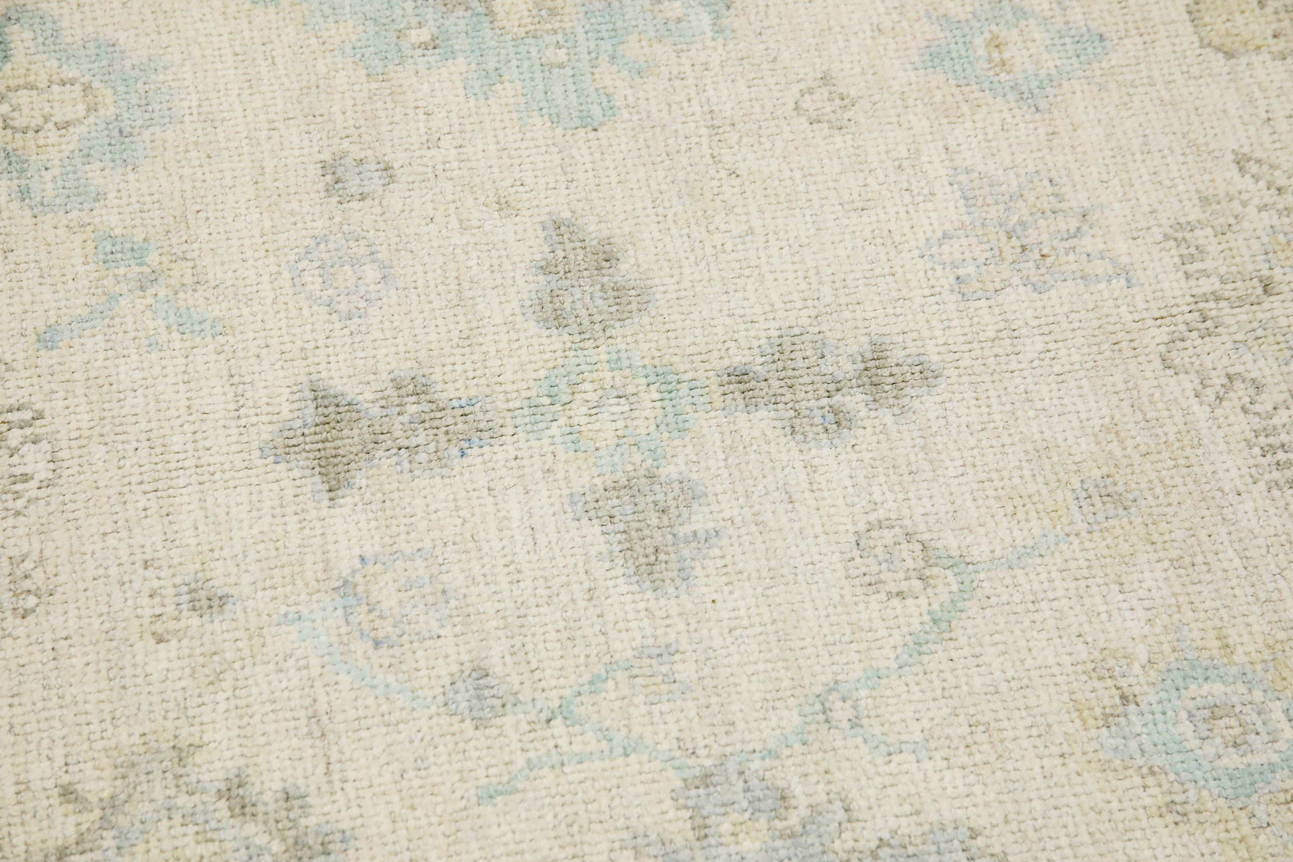 This modern Turkish Oushak rug is a stunning piece of art that has been handwoven using traditional techniques by skilled artisans. The rug features intricate patterns and a soft color palette that is achieved through the use of natural vegetable