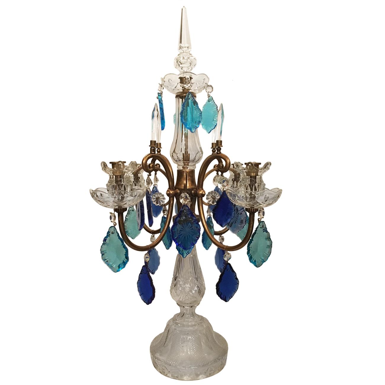 A French cut crystal candelabra with blue pendants in light and darker tones, circa 1930.