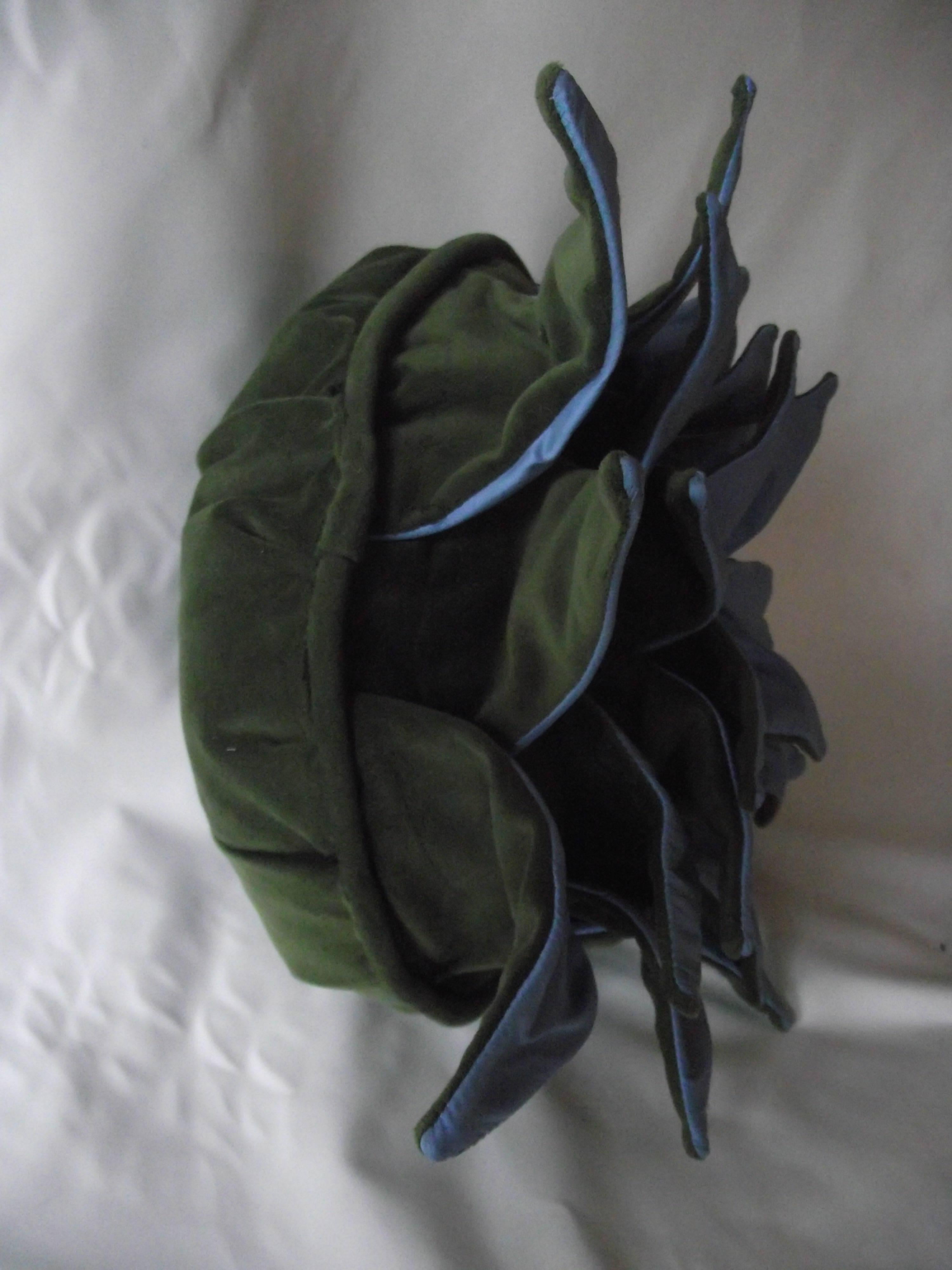 This arresting blue silk and green velvet pillow design is inspired by the Dahlia flower. A Gantt Design Studio original design, each pillow is made by hand, signed numbered and dated; It is a limited edition. Only five pillows in each color will be