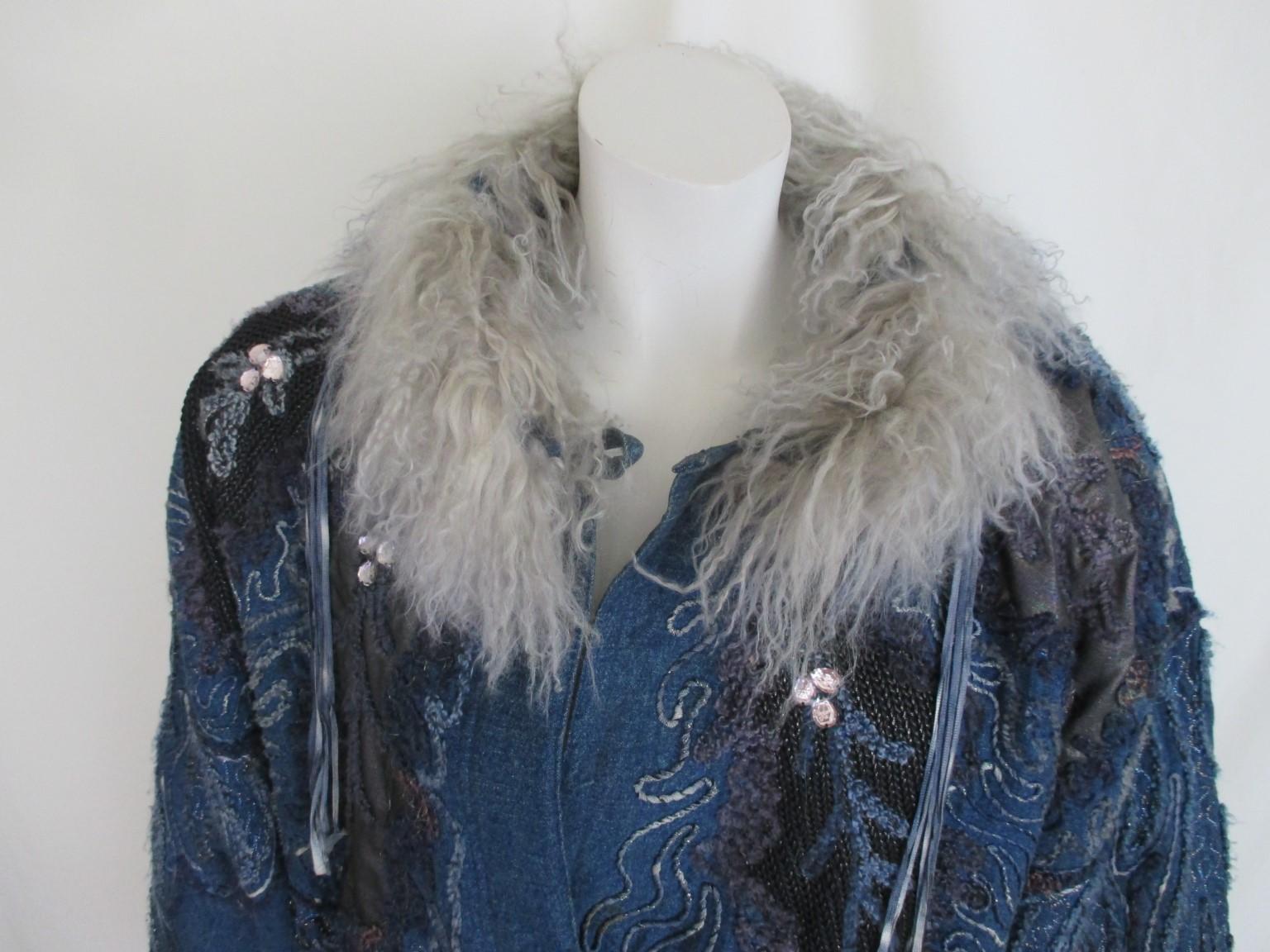 This vintage parka style embroidered jacket is made of blue denim 

We offer more exclusive vintage items, view our fronstore

Details:
With 2 side pockets, shoulderpads and 3 closing buttons.
Its handworked and embroidered with some rhine stones
