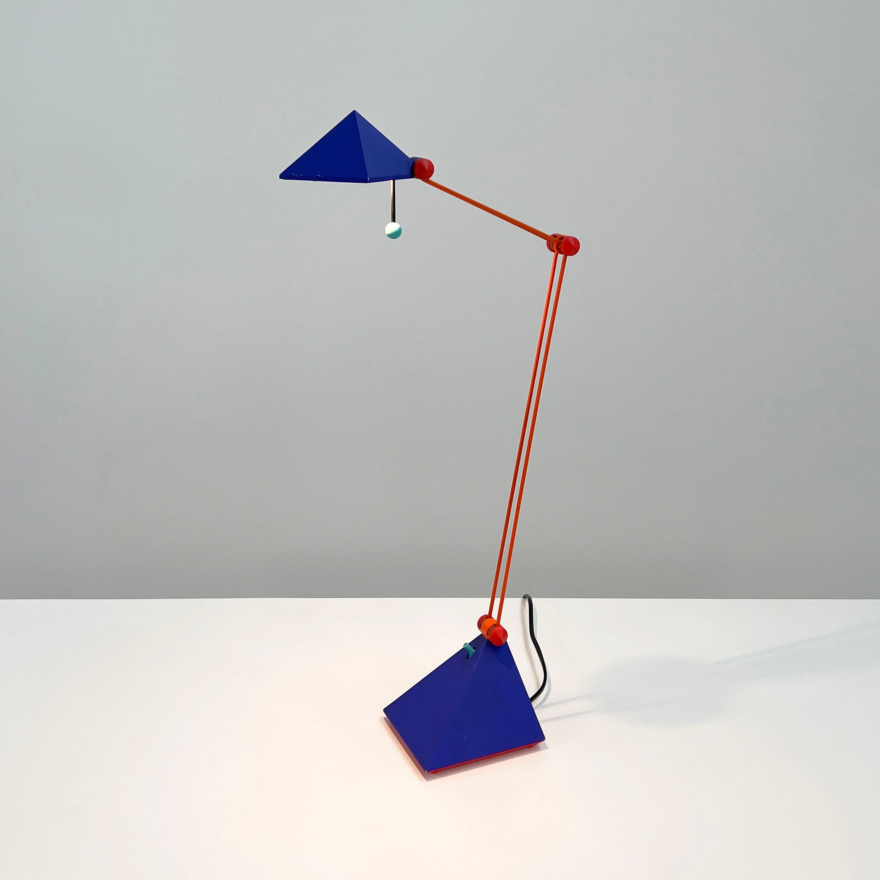 Designer - Lungean and Pellmann
Producer - Brilliant Leuchten Germany 
Design Period - Eigthies
Measurements - Width 14 cm x Depth 40 cm x Height 55 cm
Materials - Metal, Plastic
Color - Orange, Blue, Red
Light wear consistent with age and use. The