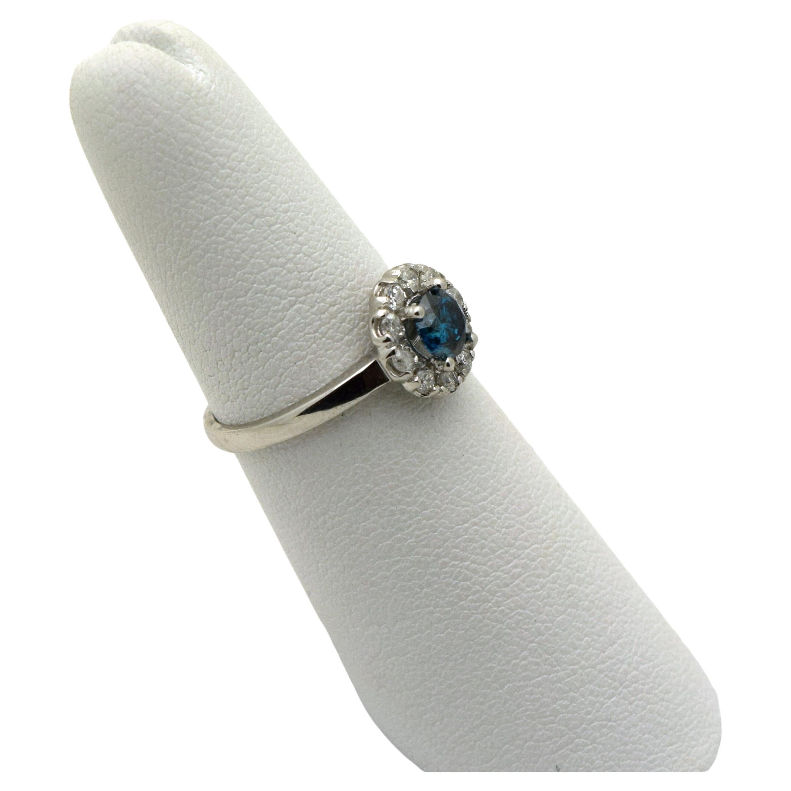 Floral Blue diamond engagement ring in 14KT white gold, what a beautiful piece! The center blue diamond is 0.50 carats, halo of white diamonds is 0.35 carats(SI clarity and F-G-H colors). The center blue diamond is color enhanced. The diamond ring