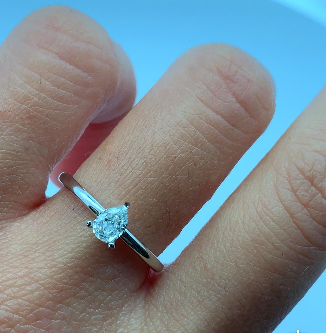 Discover the timeless beauty of this elegant blue sky pear-shaped diamond ring 18k white gold. Crafted with precision in 18k white gold, the stunning light blue diamond GIA certified total weight 0.31ct SI1 clarity is set in a sleek band, making it