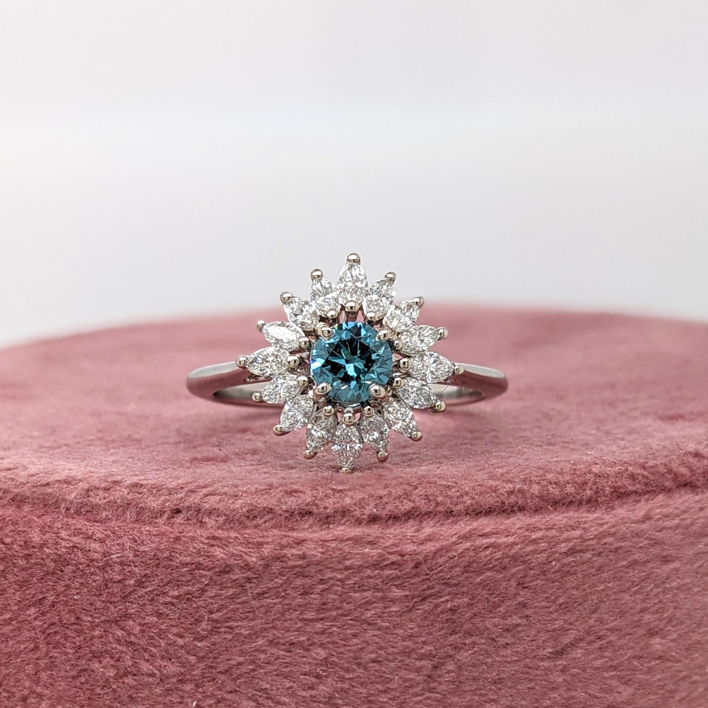 This sparkling white and blue ring is perfect for the modern bride! This beautiful ring features a rare blue round diamond with a snow flake inspired halo of natural earth-mined diamonds. 

Specifications

Item Type: Ring
Centre Stone: Blue Diamond
