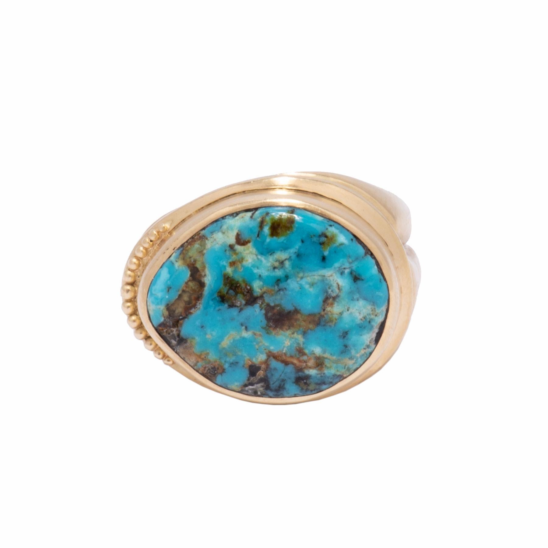 A beautifully dappled piece of Blue Diamond Turquoise rests in a softly ridged setting with a crescent of gold beads. The tapered shank is heavily scored with 3 rounded bands. An oval cabochon of Blue Diamond Turquoise with a matrix of browns and