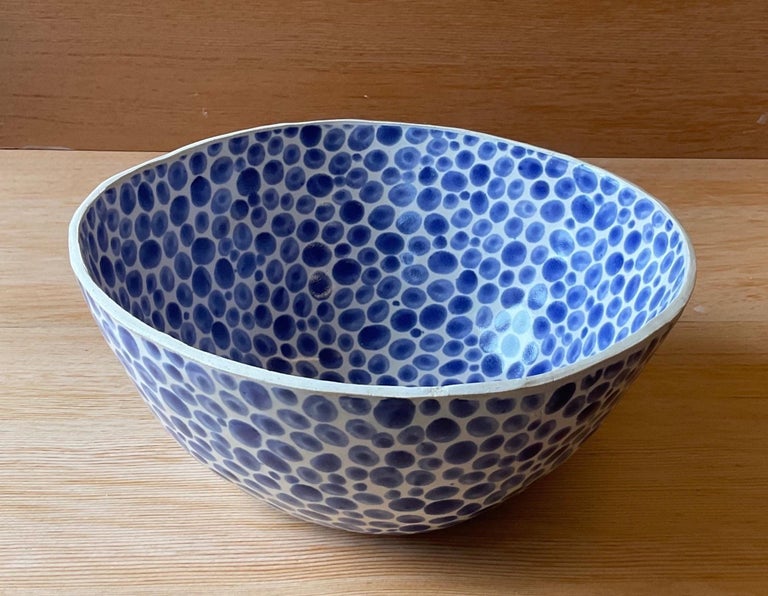 White Stoneware Fruit bowl. Glazed with hand-painted blue dots. Measures: 8.5