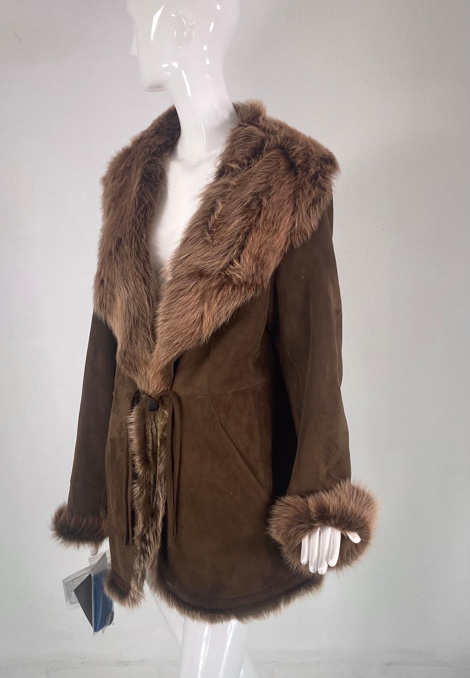 Blue Duck micro Spanish merino light weight shearling coat NWT. A beautiful coat or long jacket with a wide lapel collar of long soft fur, long sleeves with turn back fur cuffs. The coat closes at the waist with a horn button and leather ties, there
