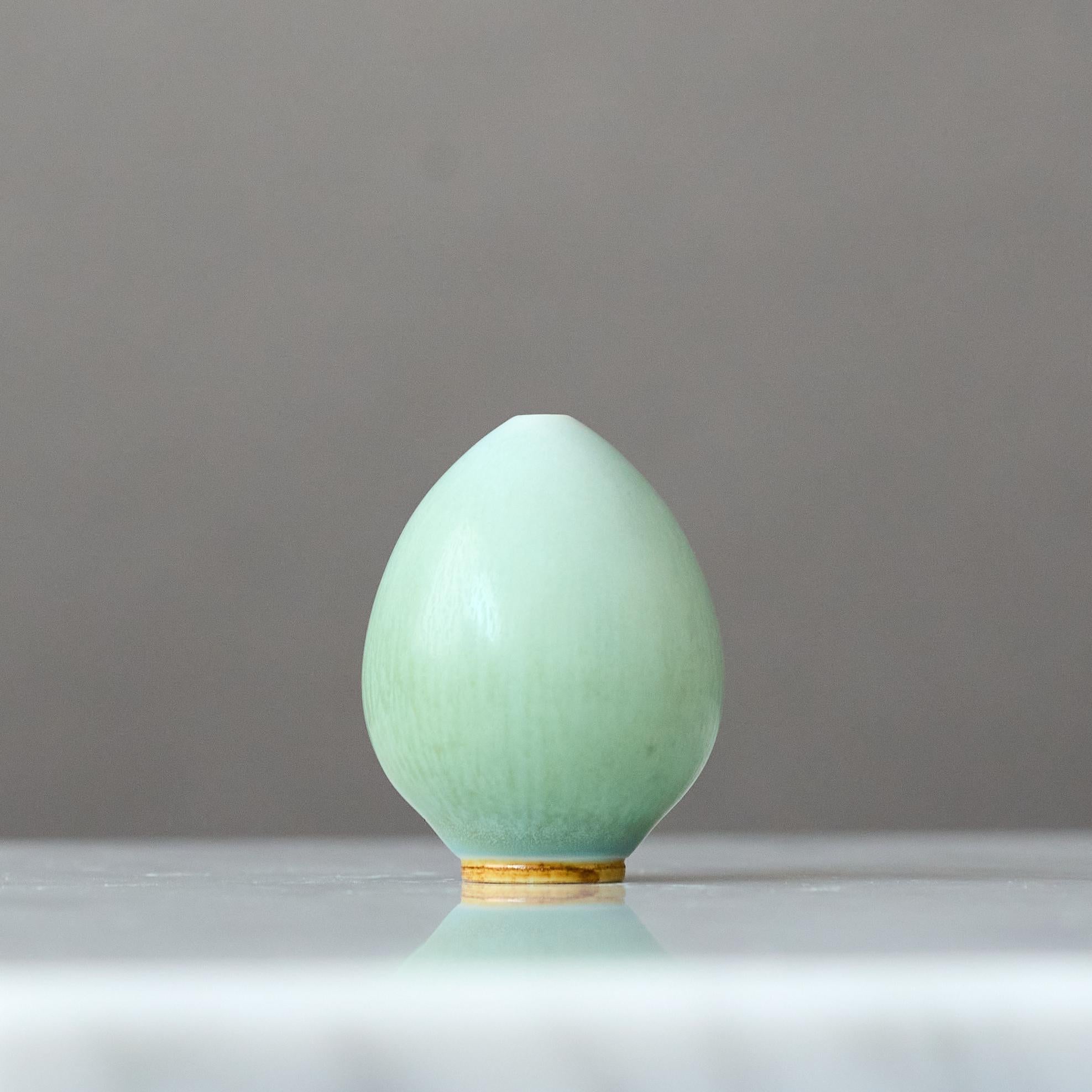 A beautiful egg-shaped stoneware miniature vase with amazing celadon / blue-green hare’s fur glaze.
Made by master thrower Berndt Friberg, in the artist's studio at Gustavsberg, Sweden, 1960s.

Great condition. 
Incised signature 