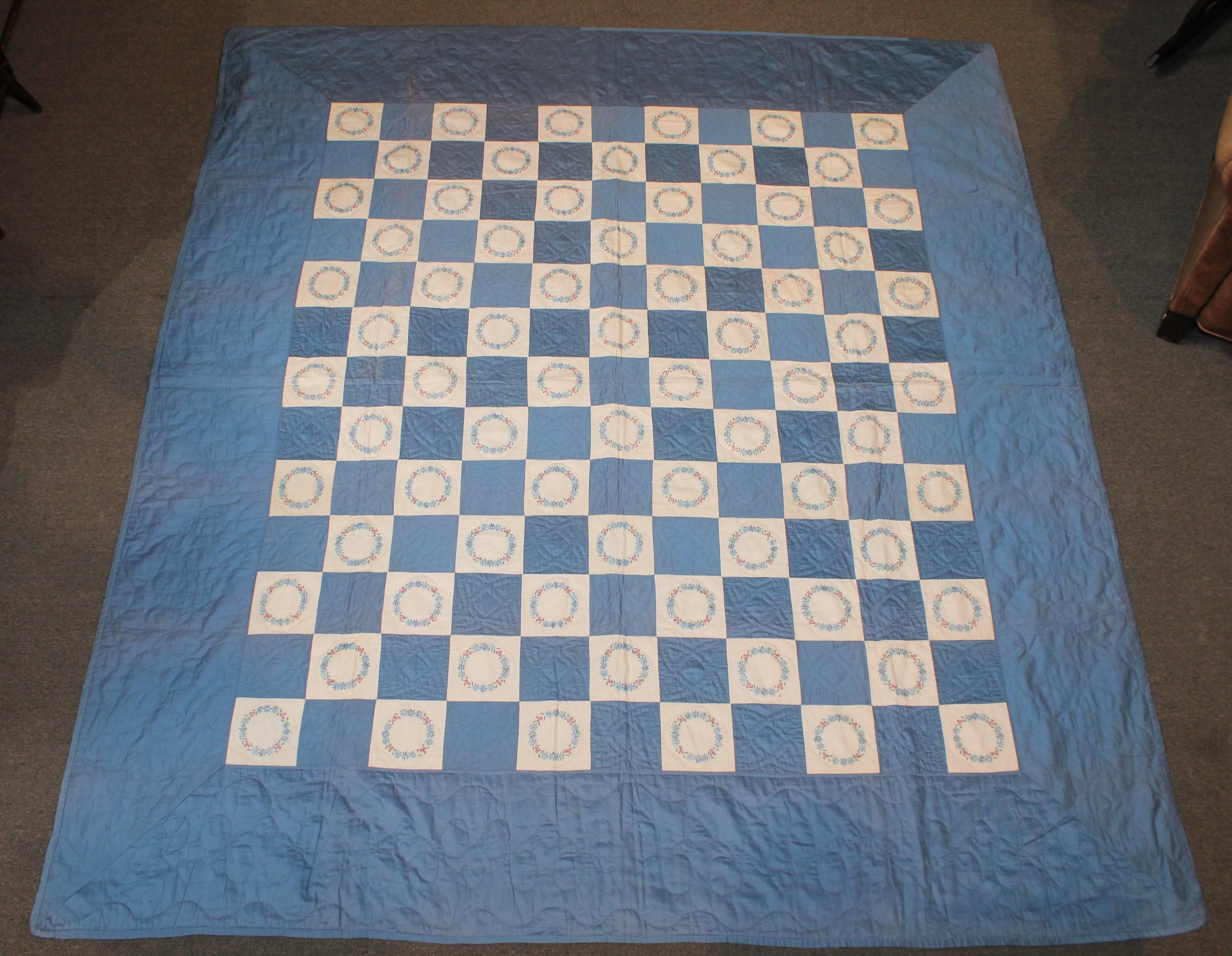 This finely quilted blue and white sateen quilt is in fine condition. Minor fold fade in areas.
