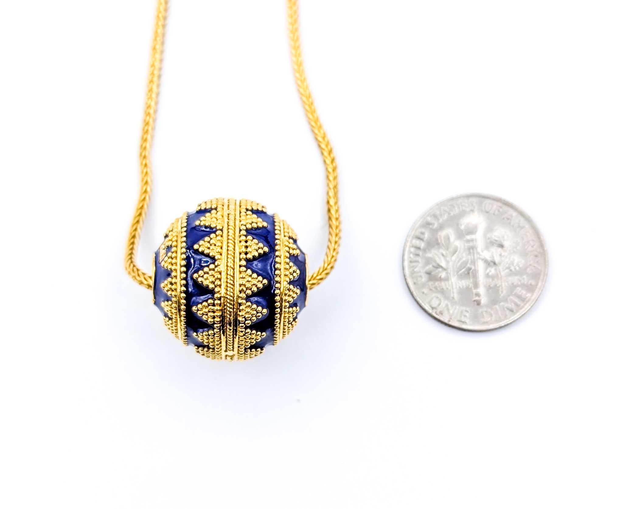 Blue Enamel Ball Bead and Wheat Chain Necklace in 22K Yellow Gold
Introducing this striking Gold Ball Bead Necklace, beautifully crafted in rich 22K yellow gold. The necklace features a 19mm ball bead with beautiful texture and dark blue enamel with