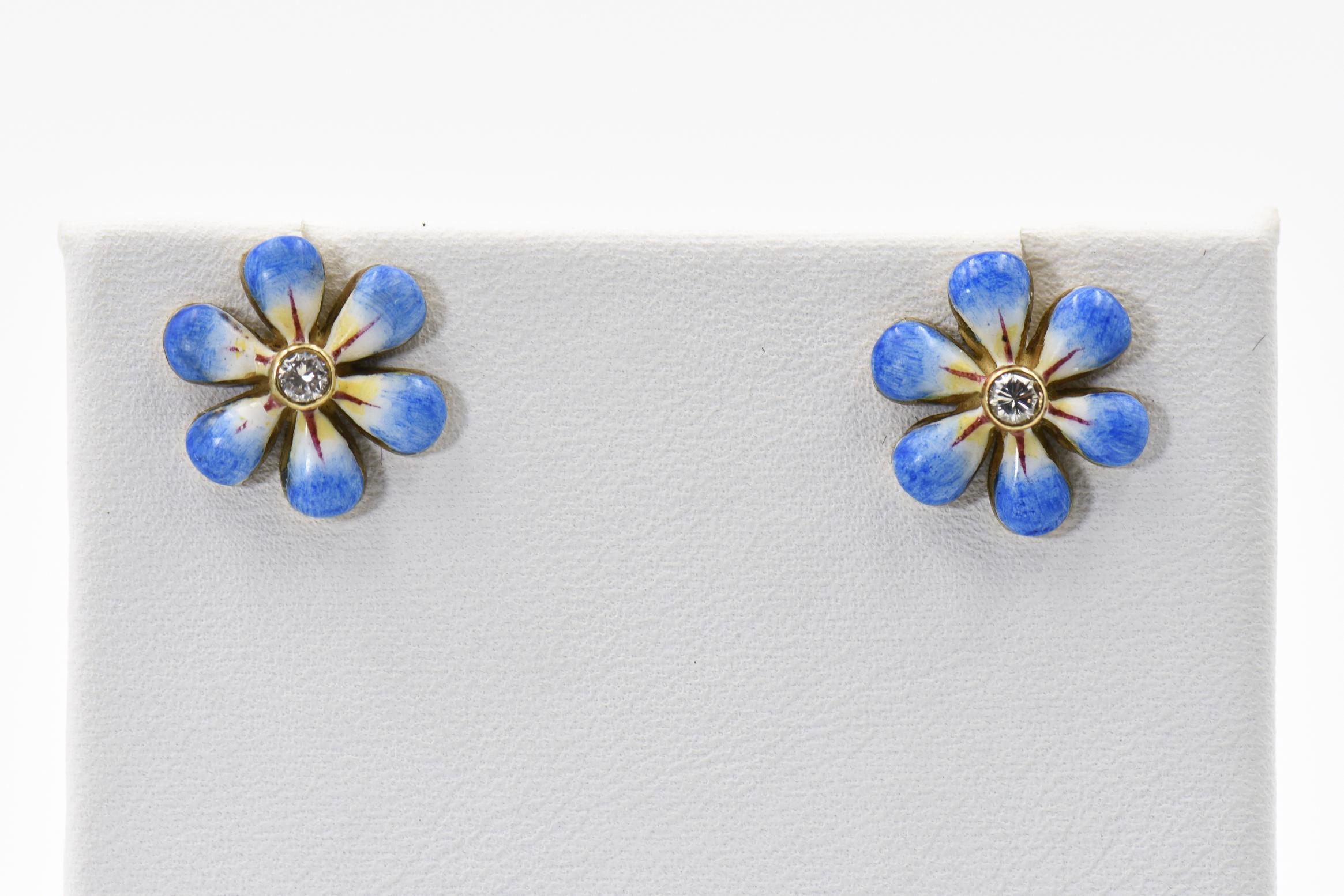 This pair of blue enamel daisy earrings are part of the daisy line, a beautiful handmade line of jewelry by Sandra J. Sensations. Each flower is hand painted by an enamel artist. The flowers are 14k with diamonds in the center. Each diamond is