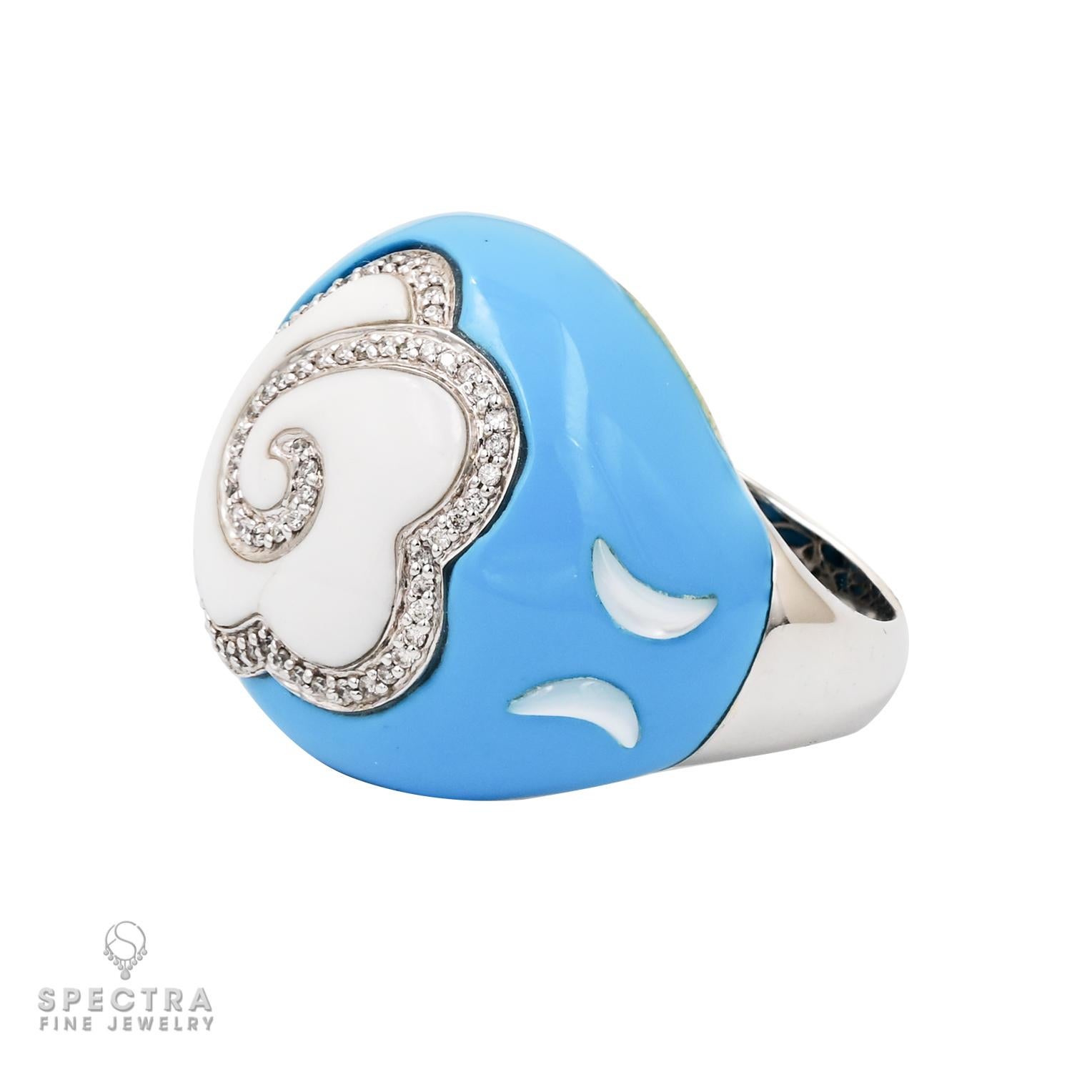 This lovely Enamel Diamond 'Dome' Ring, crafted in 18K white gold, showcases a captivating design. Adorned with a delightful sky blue enamel on its domed shape, the ring features a central white enamel cloud, intricately intersecting the blue with