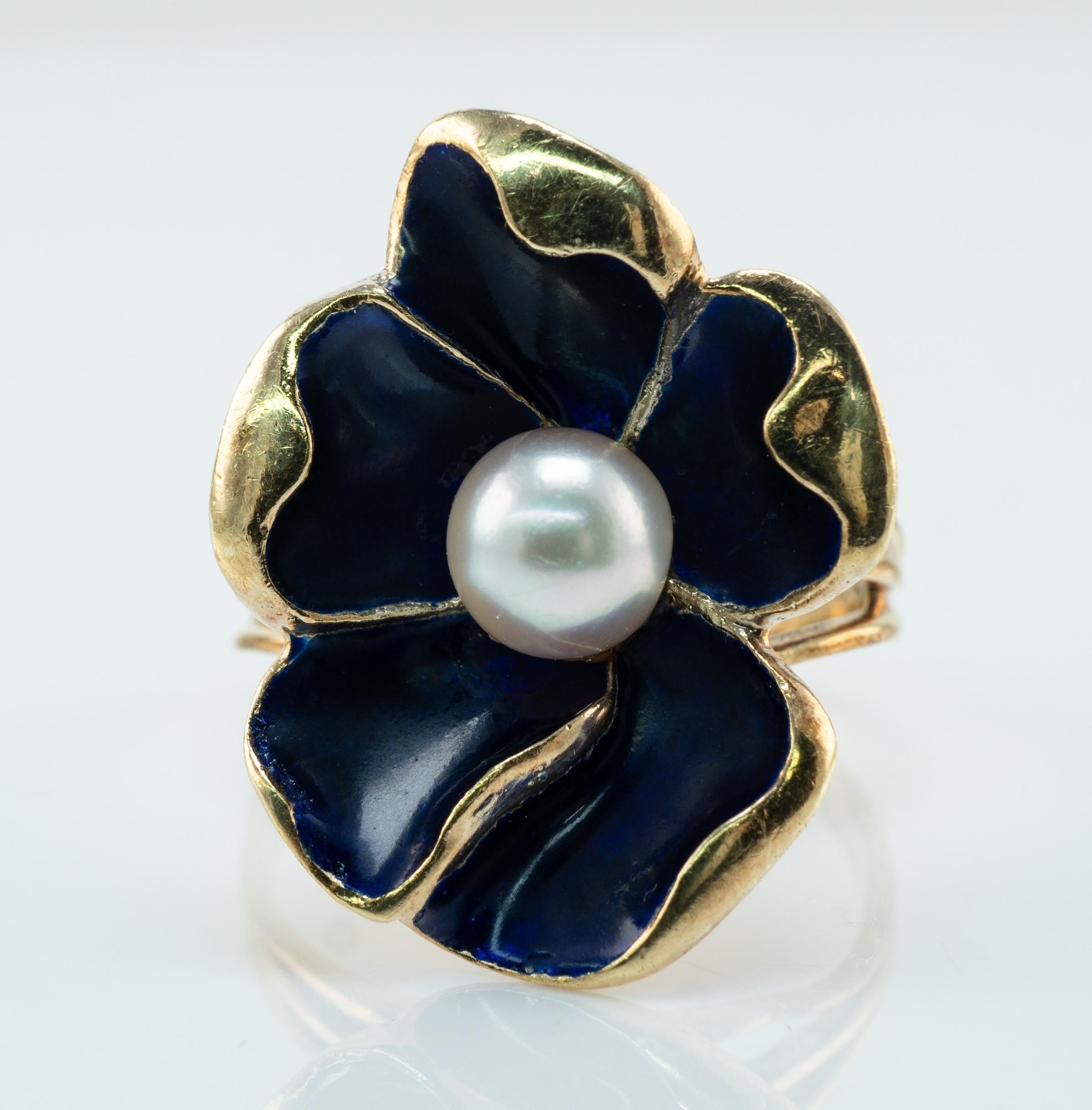 Blue Enamel Pearl Ring Flower 14K Gold Vintage

This pretty vintage ring is crafted in solid 14K gold. The natural cultured Pearl measures 7mm. The blue enamel on the petals is in good condition. The top of the ring measures 25mm x 20mm. The setting