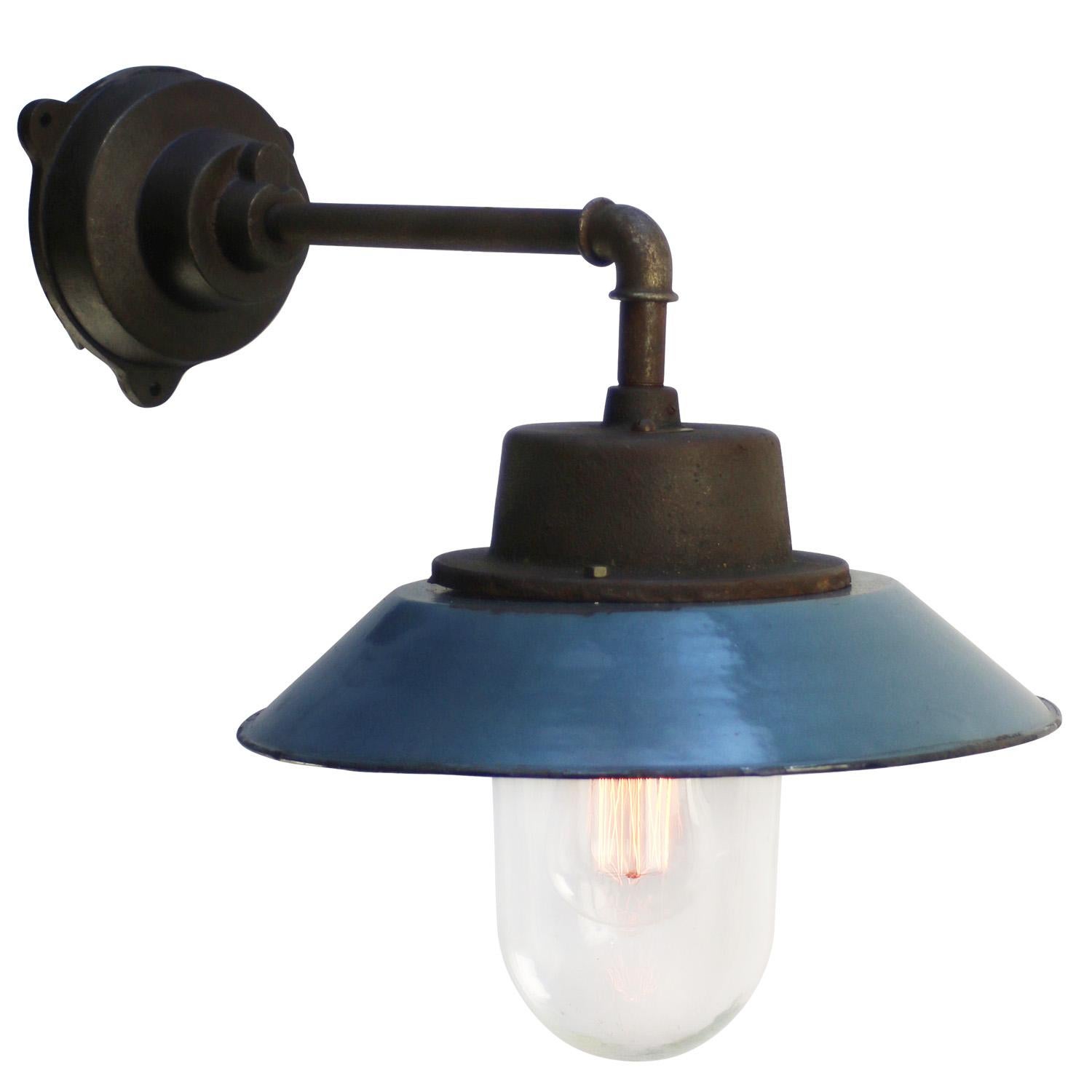 Blue enamel industrial wall light.
Cast iron top, white enamel interior, clear glass

Diameter cast iron wall mount: 12 cm, 3 holes to secure.

Weight: 5.5 kg / 12.1 lb

For use outdoors as well as indoors. 

Priced per individual item. All lamps