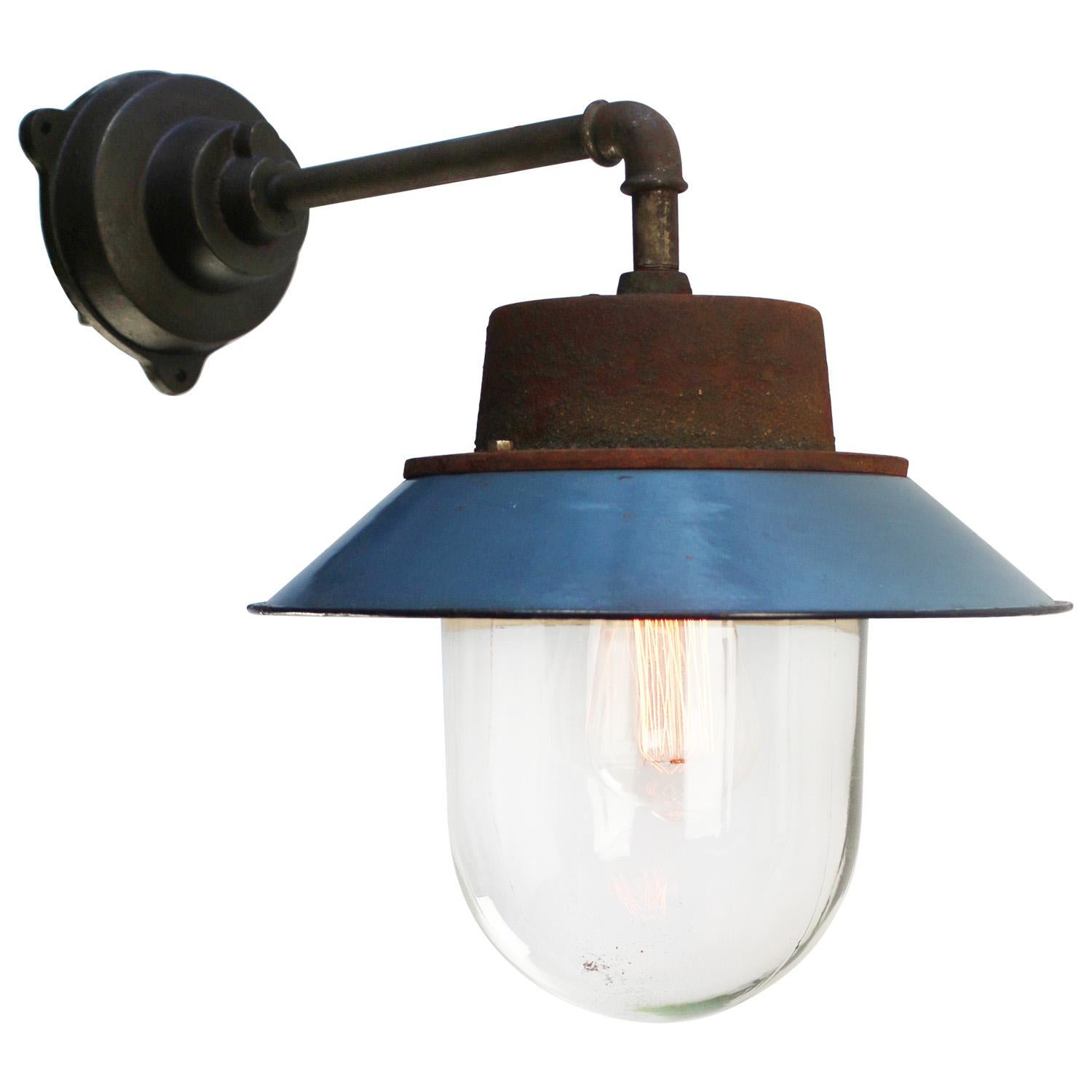 Blue enamel industrial wall lamp with white interior.
Clear glass. 

Diameter cast iron wall piece: 12 cm. Three holes to secure.

Weight: 6.70 kg / 14.8 lb

Priced per individual item. All lamps have been made suitable by international standards