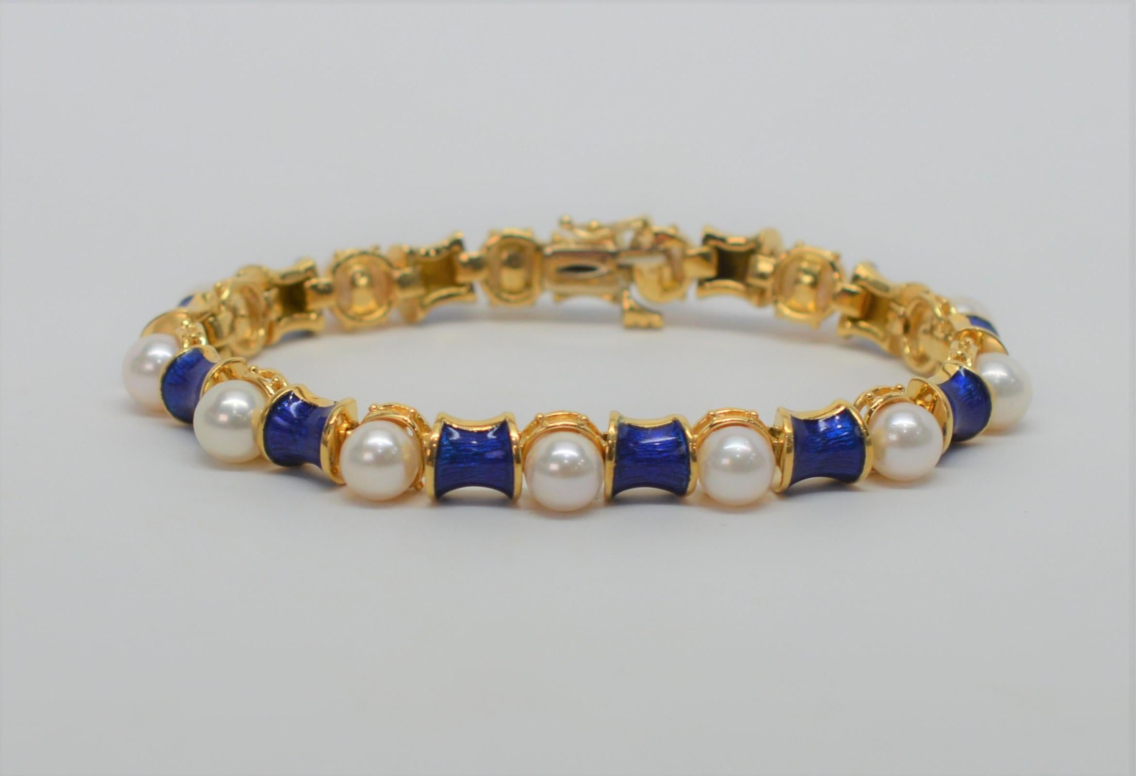 Round 6mm AAA white Akoya pearls accent the vivid cobalt blue hand painted enamel links of this eighteen karat 18K yellow gold bracelet. Measures seven inches in length, and finished with a plunger clasp and safety clip. Gift boxed. 