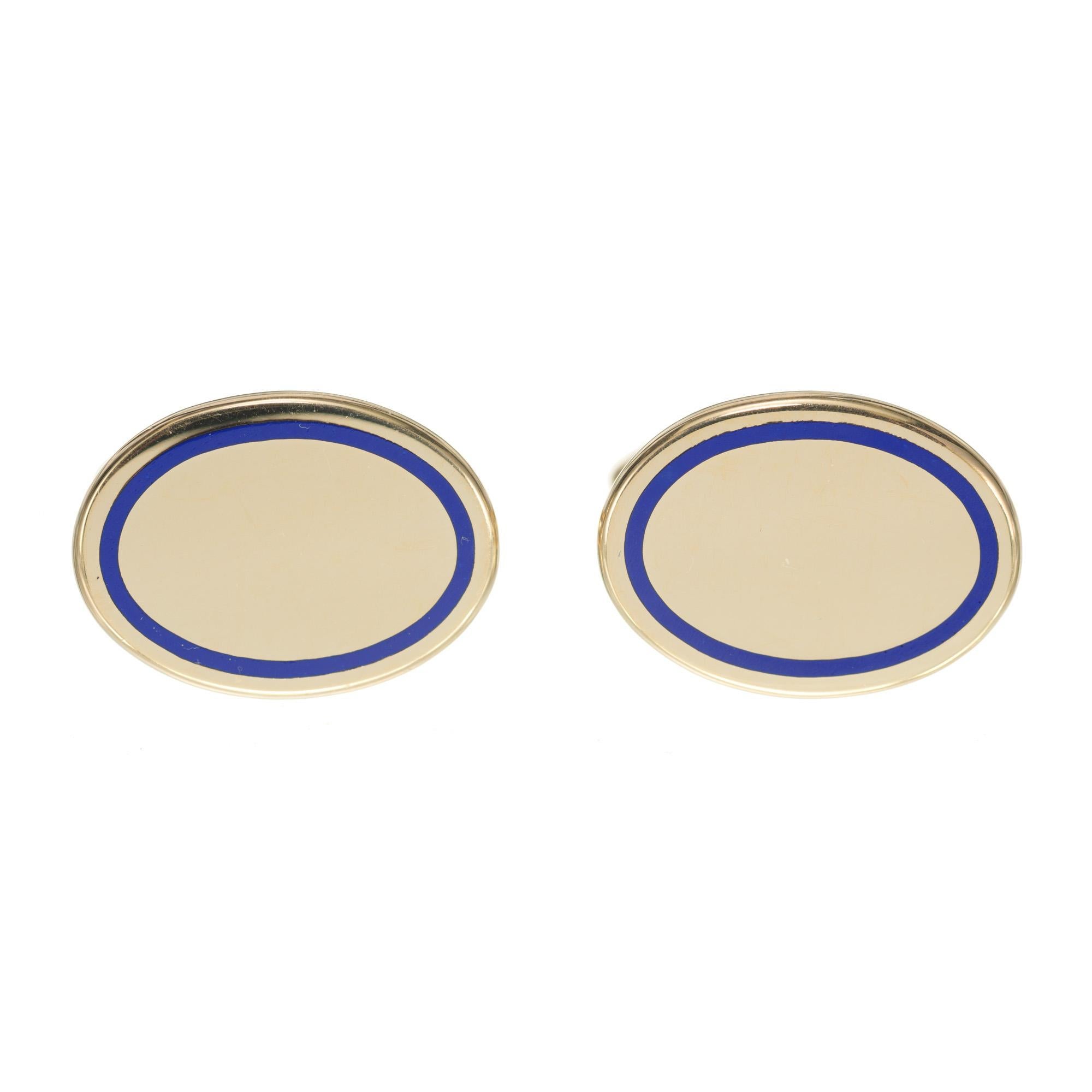 1960's 14k yellow gold cufflinks. Oval shaped, each with a blue oval enamel rim. 

14k yellow gold 
Stamped: 14k
15.7 grams
Top to bottom: 16.4mm or 5/8 Inches
Width: 22.3mm or 7/8 Inch
Depth or thickness: 1.75mm
