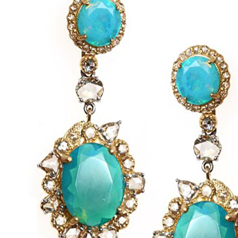 Affinity Earrings Set in 20 Karat Yellow Gold with 6.42 Carat Blue Ethiopian Opals and 2.67 Carat Diamonds. The Yellow Gold Compliments The Natural Blue and Green Flashes In These Timeless Opal Gemstones.