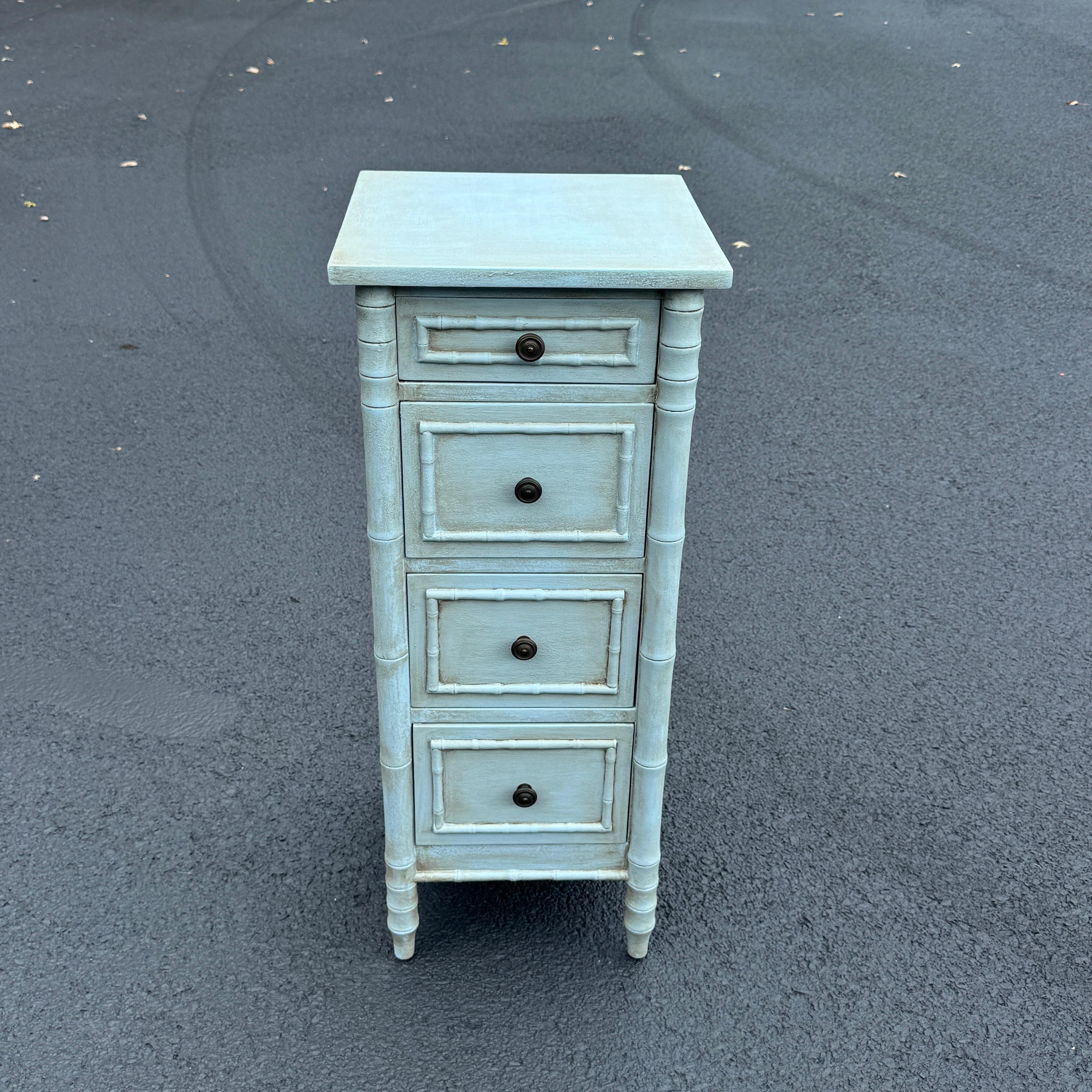 Solid and charming best describe this 4 drawer faux bamboo painted in Gustavian blue. This versatile piece could function well in a foyer, bathroom, bedroom storing lingerie and jewelry, or any room needing that small narrow piece.  