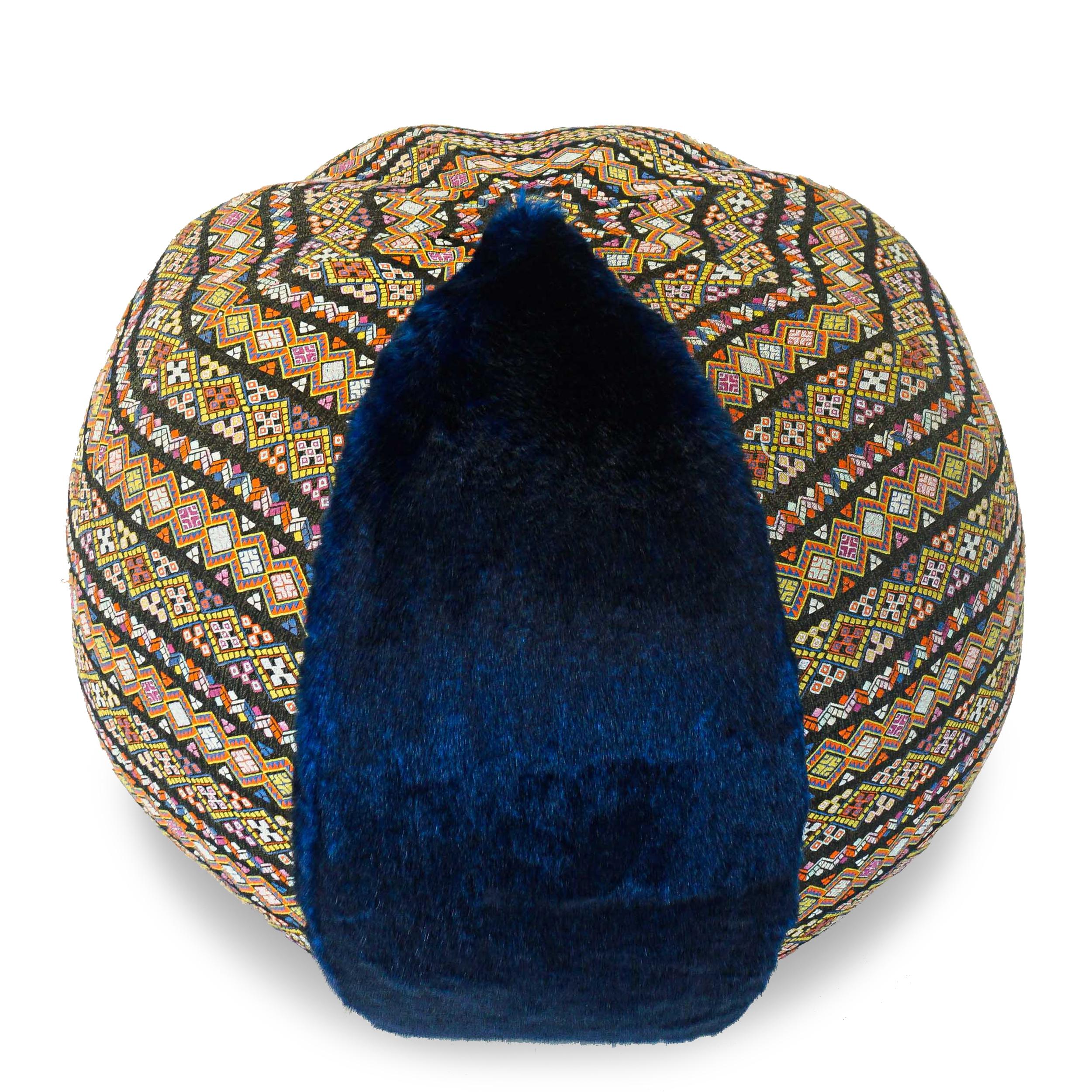 Handmade pouf/ottoman covered in vibrant blue faux fur & patterned Bohemia style fabric. Light enough to move around as occasional seating without scratching floor, but substantial and firm enough to support a serving tray or adult size bottom