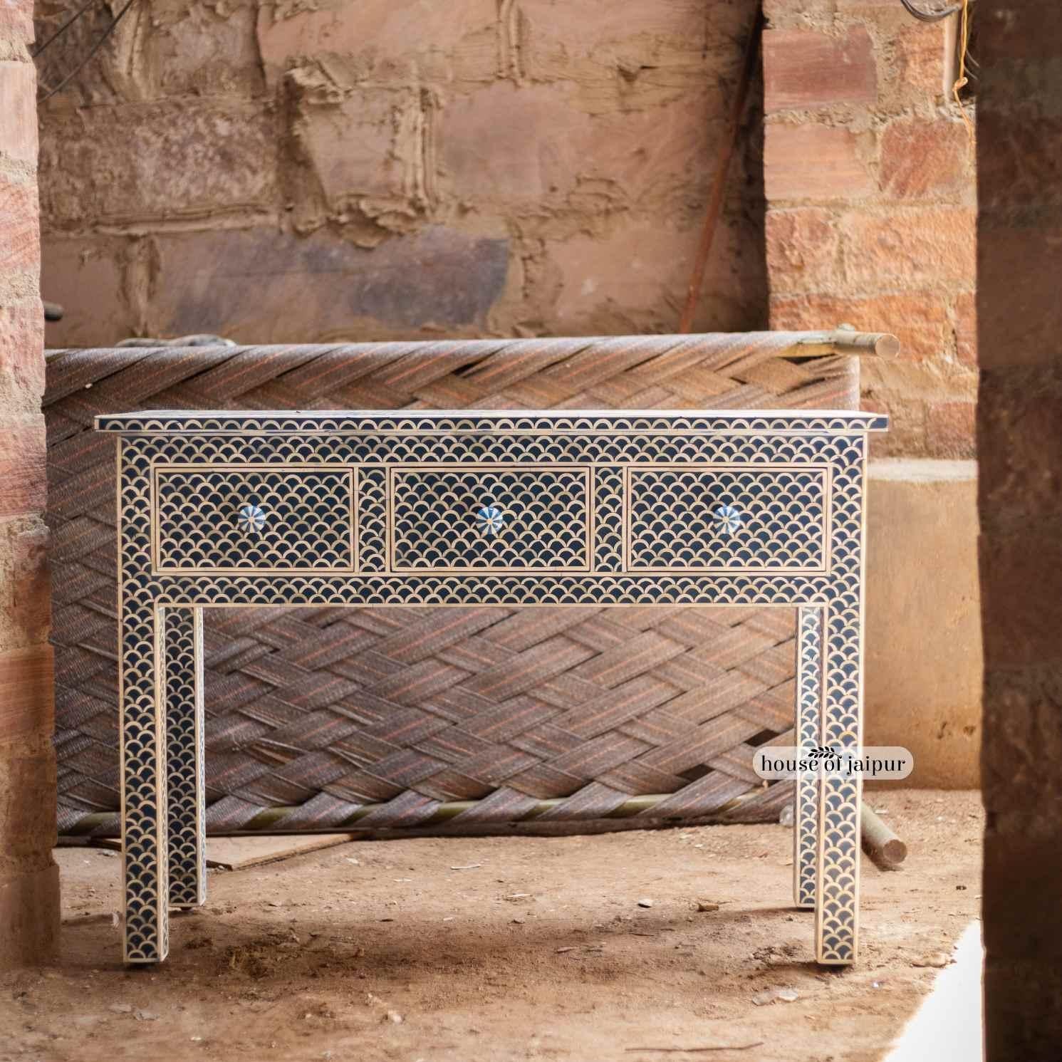 A beautifully handcrafted statement piece, this Bone Inlay Console Table features a rich blue base paired with an elegant fishscale (scallop) inlay pattern. Each bone tile is individually hand-cut, shaped, and meticulously placed by skilled