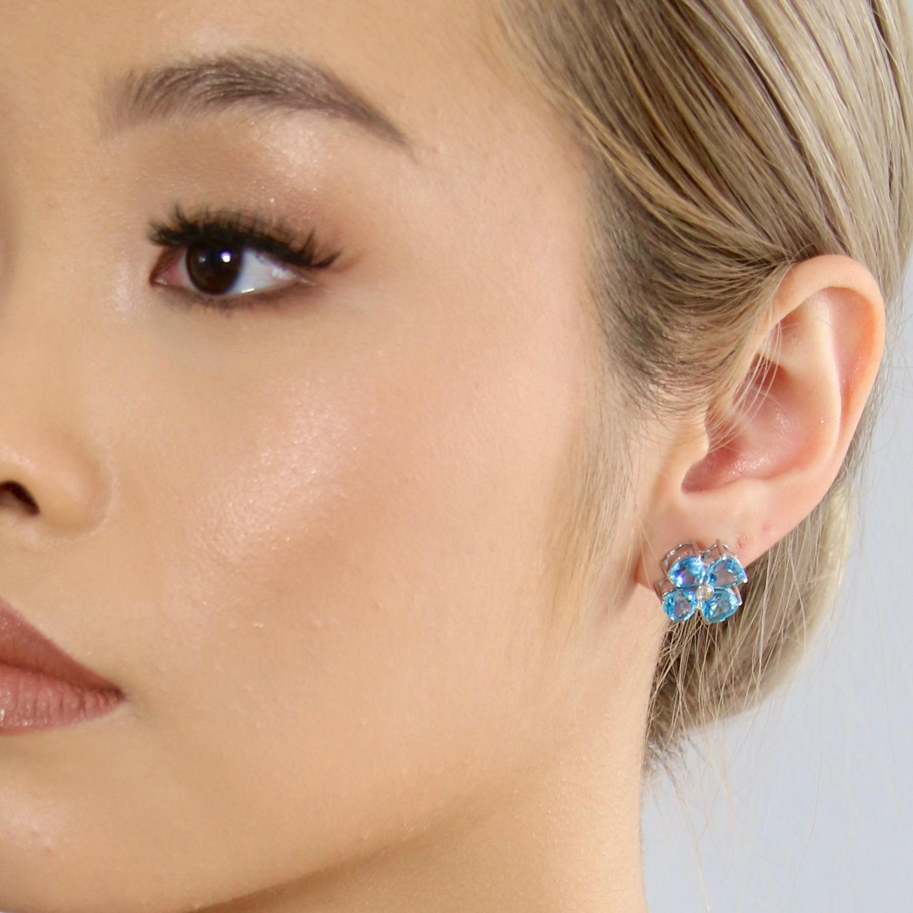 18K Solid White Gold

Natural Swiss Topaz Gemstone: Heart Shape, Size 6x6mm

Natural Diamond: Round Cut, Size 2.5mm

Earrings: Flower Shape 

Gross Weight: 7.2g

Elevate your look with these exquisite earrings crafted from 18K Solid White Gold. The