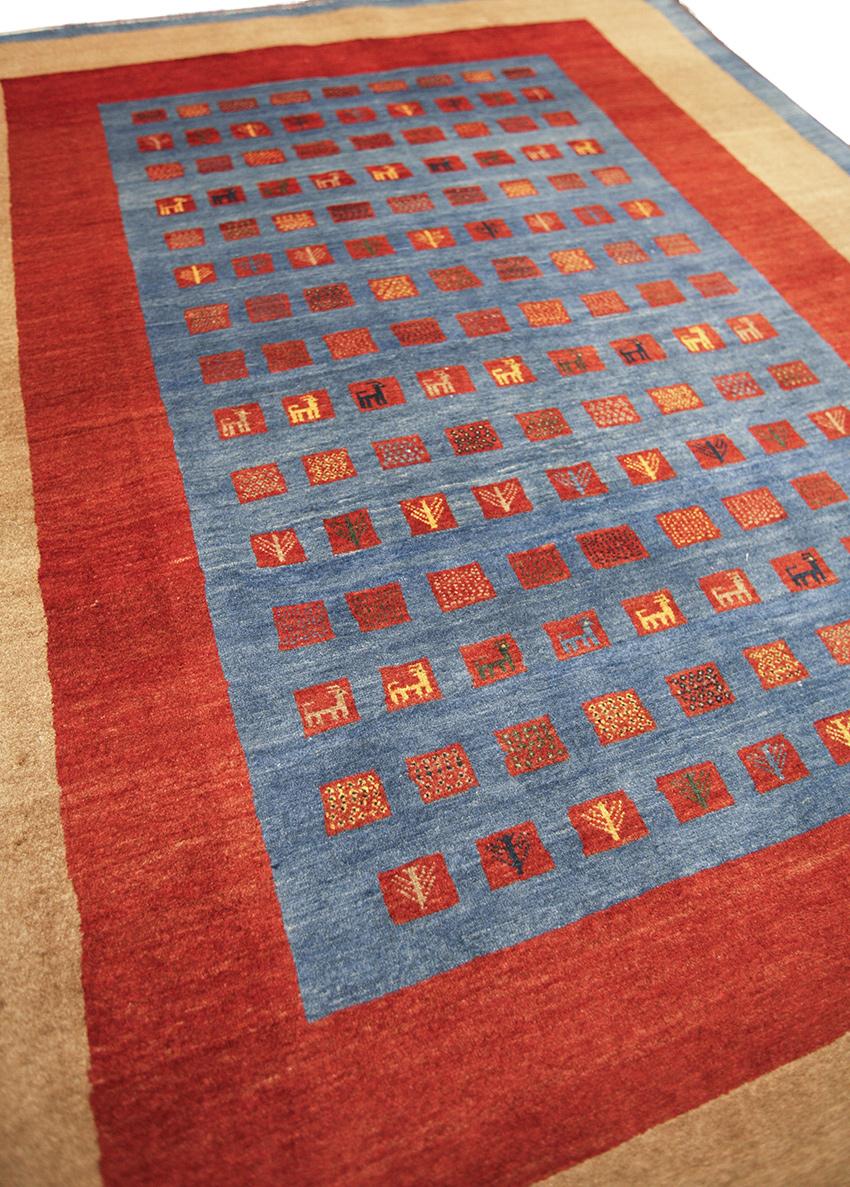 This is a Blue Gabbeh Rug - a timeless masterpiece blending minimalist design with special tribal elements. This exquisite rug showcases a captivating fusion of modern elegance and traditional charm, making it a truly remarkable addition to any