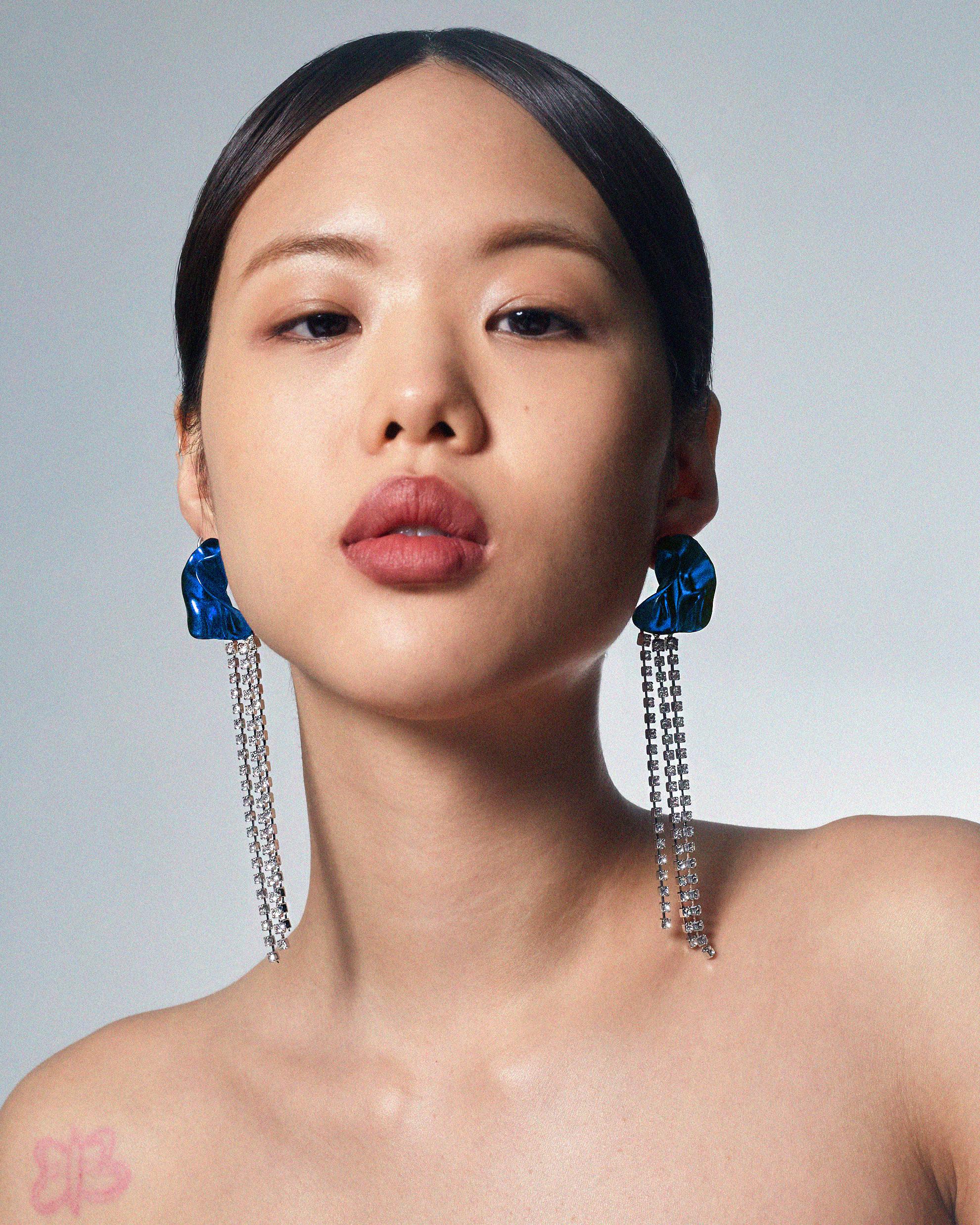 The Georgia crystal-embellished earrings from Sterling King feature a sculptural shape with cascading crystals. Inspired by the works of Georgia O'Keeffe, these floral-inspired earrings are finished with a vibrant metallic blue. Lightweight and