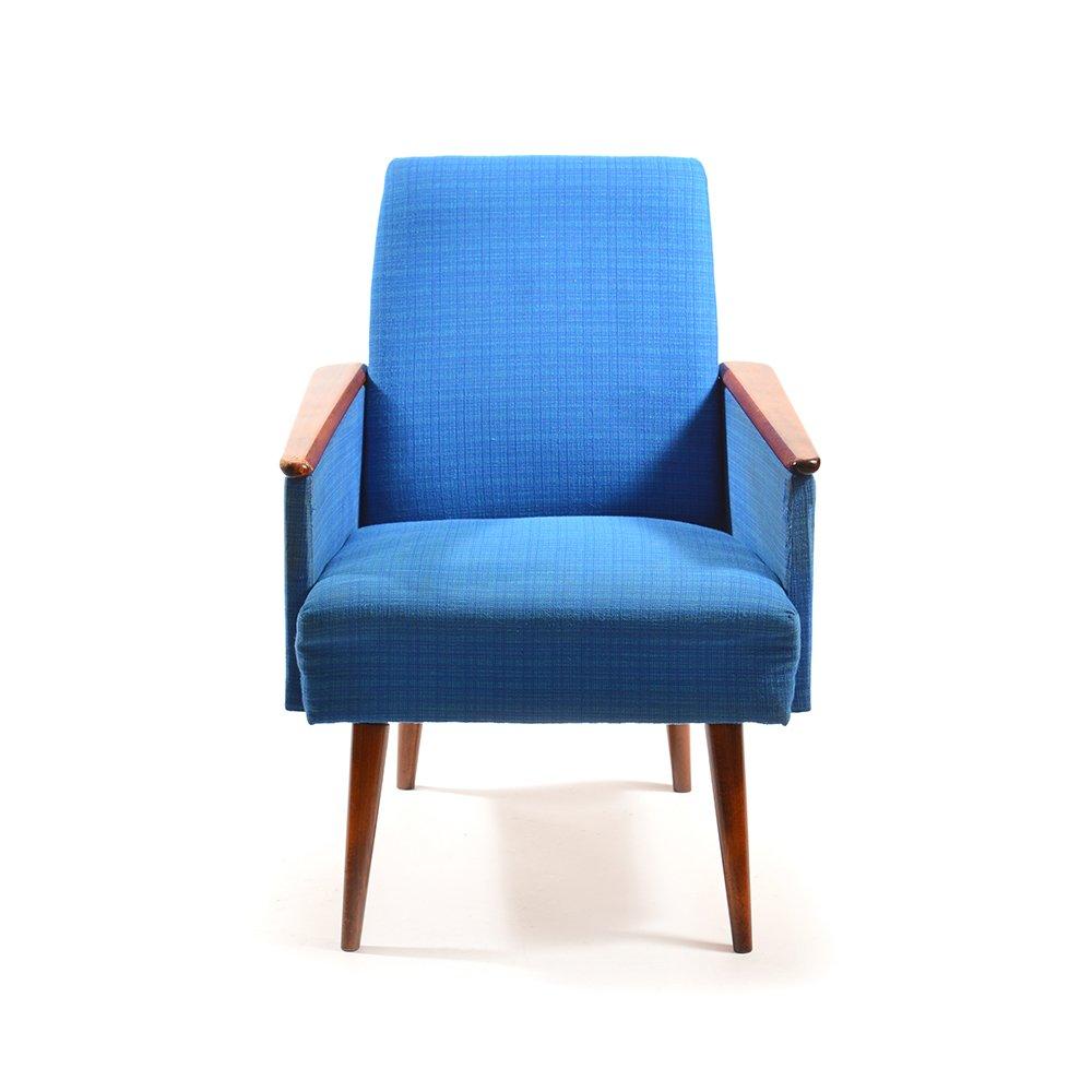 Blue armchair made in German Democratic Republic in the 1970s. Upholstered in bright blue. Wooden details of cherry finish. Beautiful combination. Wood with some patina and minor wear. Beautiful item.