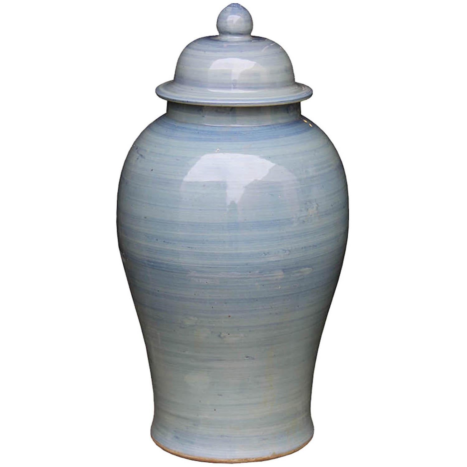 Contemporary ceramic ginger jar has been hand painted in varying shades of blue.  Use on a dining table, buffet or on book shelf.  Available and priced individually. Jar on the right is 21-1/2