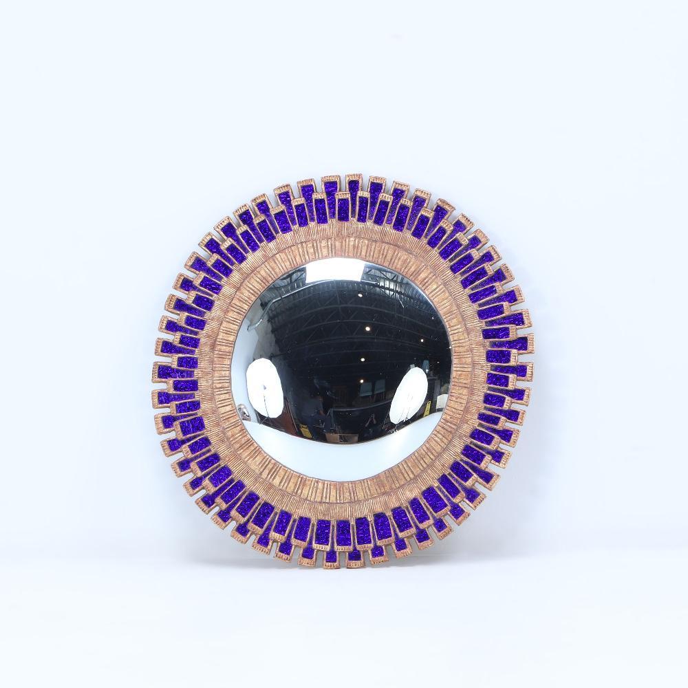 This large electric cobalt blue glass and gold resin convex mirror is in a 