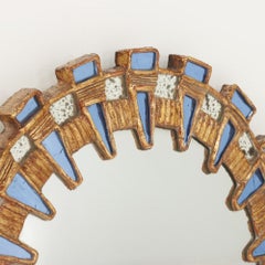 Blue glass and resin convex mirror in the manner of Line Vautrin's Tudor design.