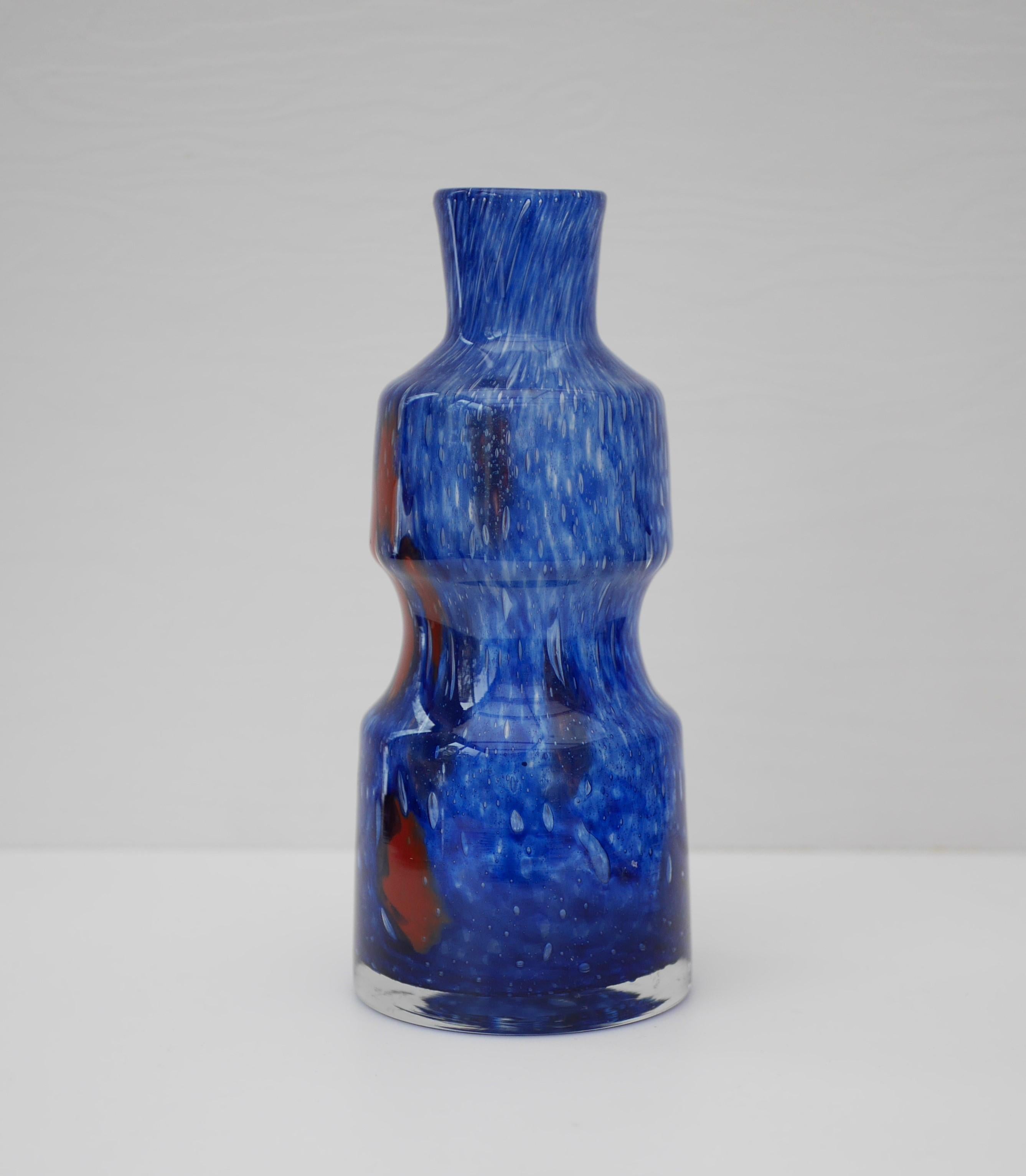 Stunning, iridescent blue glass 'Flora' vase with red details. Made by Frantisek Koudelka for Prachen, Czech Republic, 1970s. This is a rare piece.

From the Mid-Century but has a Bohemian design with air bubbles integrated into the colour flow.