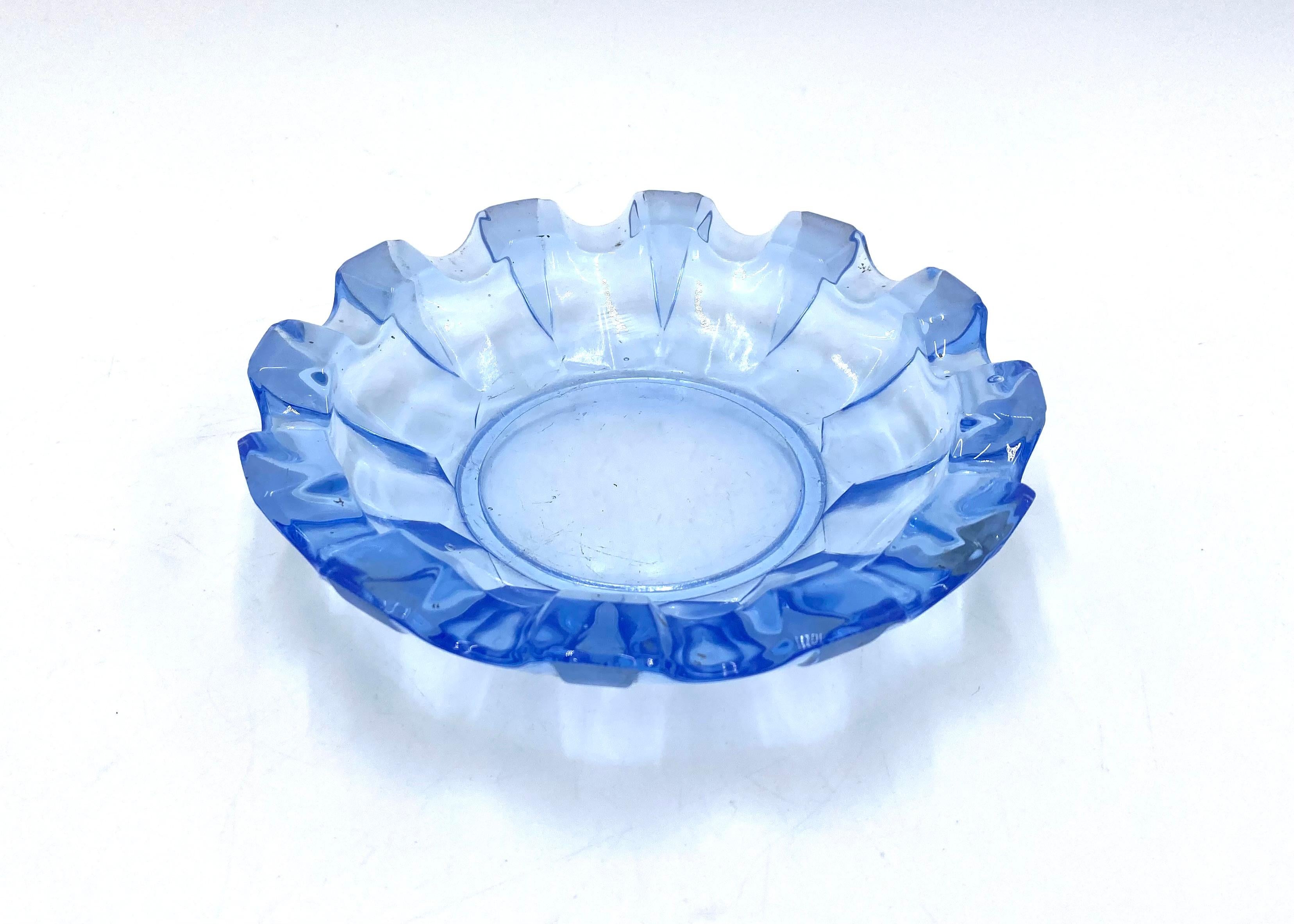 Blue glass ashtray.

Made in the Czech Republic in the 1930s.

height 3.5 cm; 17.5 cm diameter.