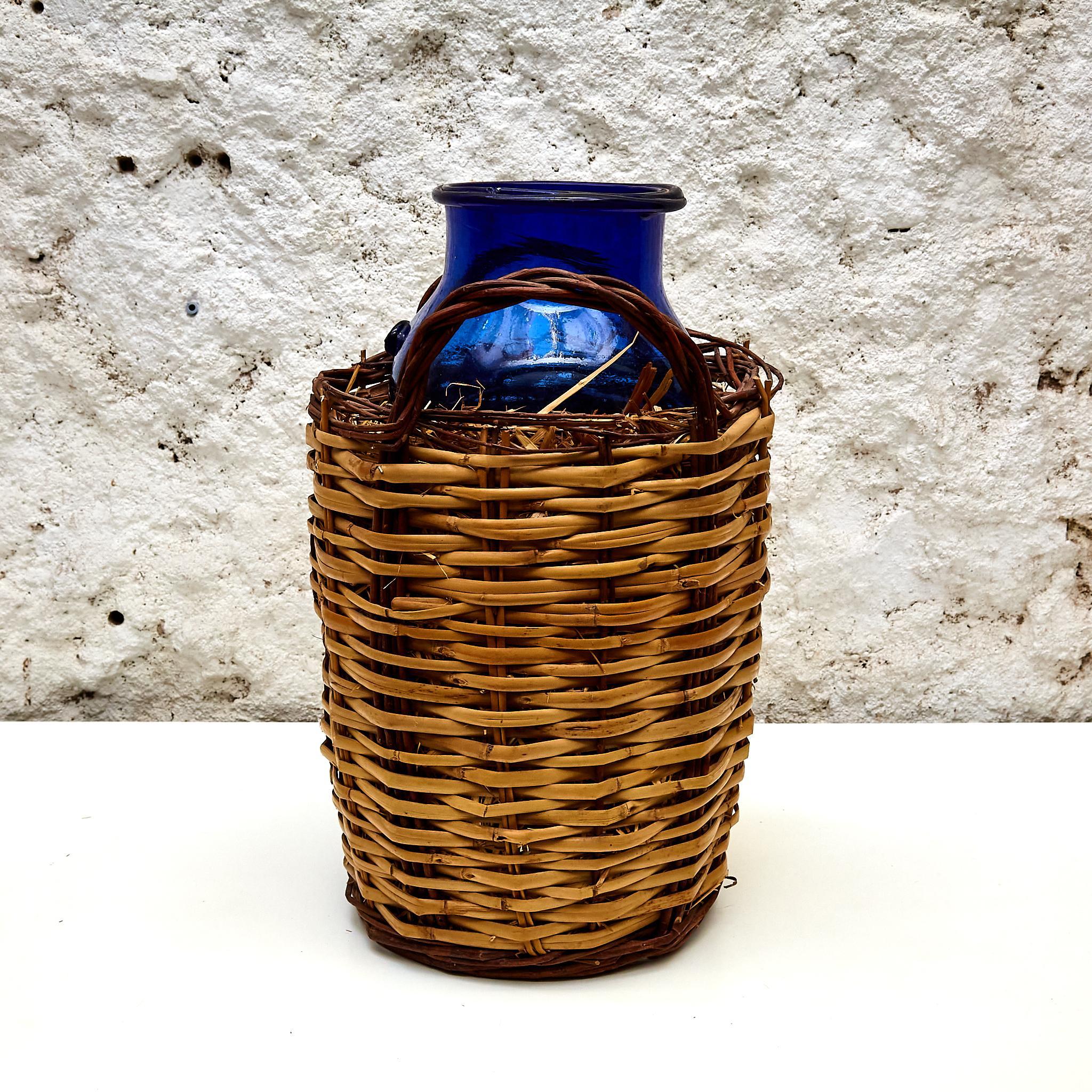French Blue Glass Bottle with Wicker Basket, circa 1930 For Sale